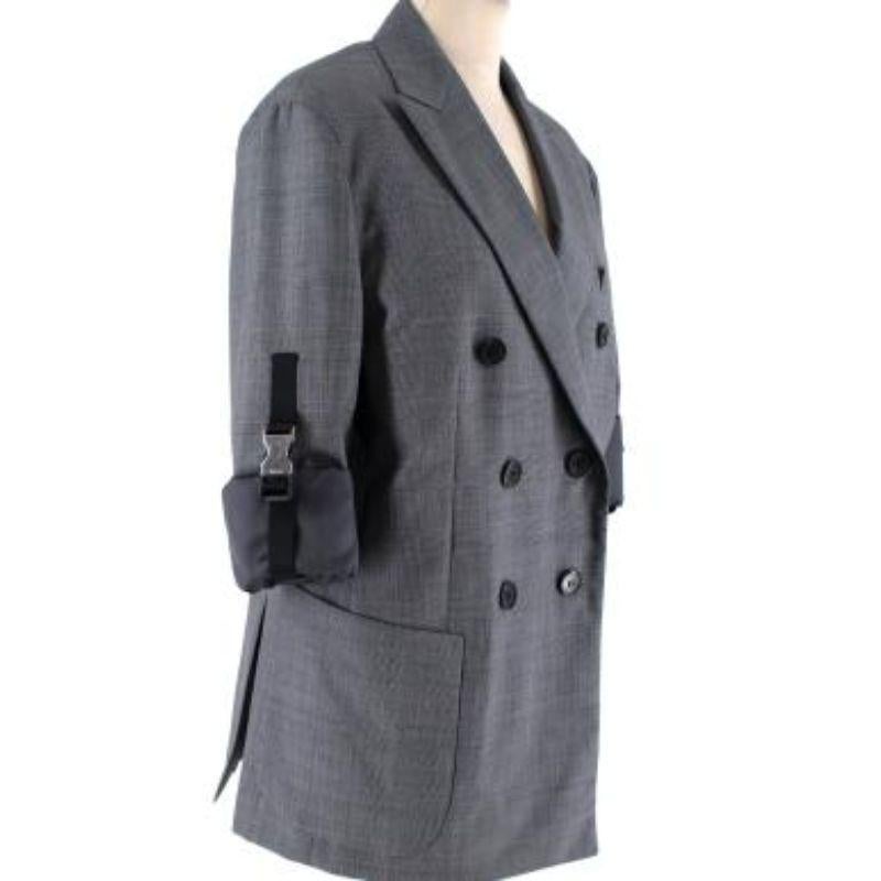 Prada Grey wool Prince of Wales checked blazer
 

 - Double-breasted with peak lapels
 - 3/4 sleeve with signature silver-tone metal and webbing buckle strap 
 - Lightweight wool cloth 
 - One non-functioning breast pocket 
 - Two functioning slip