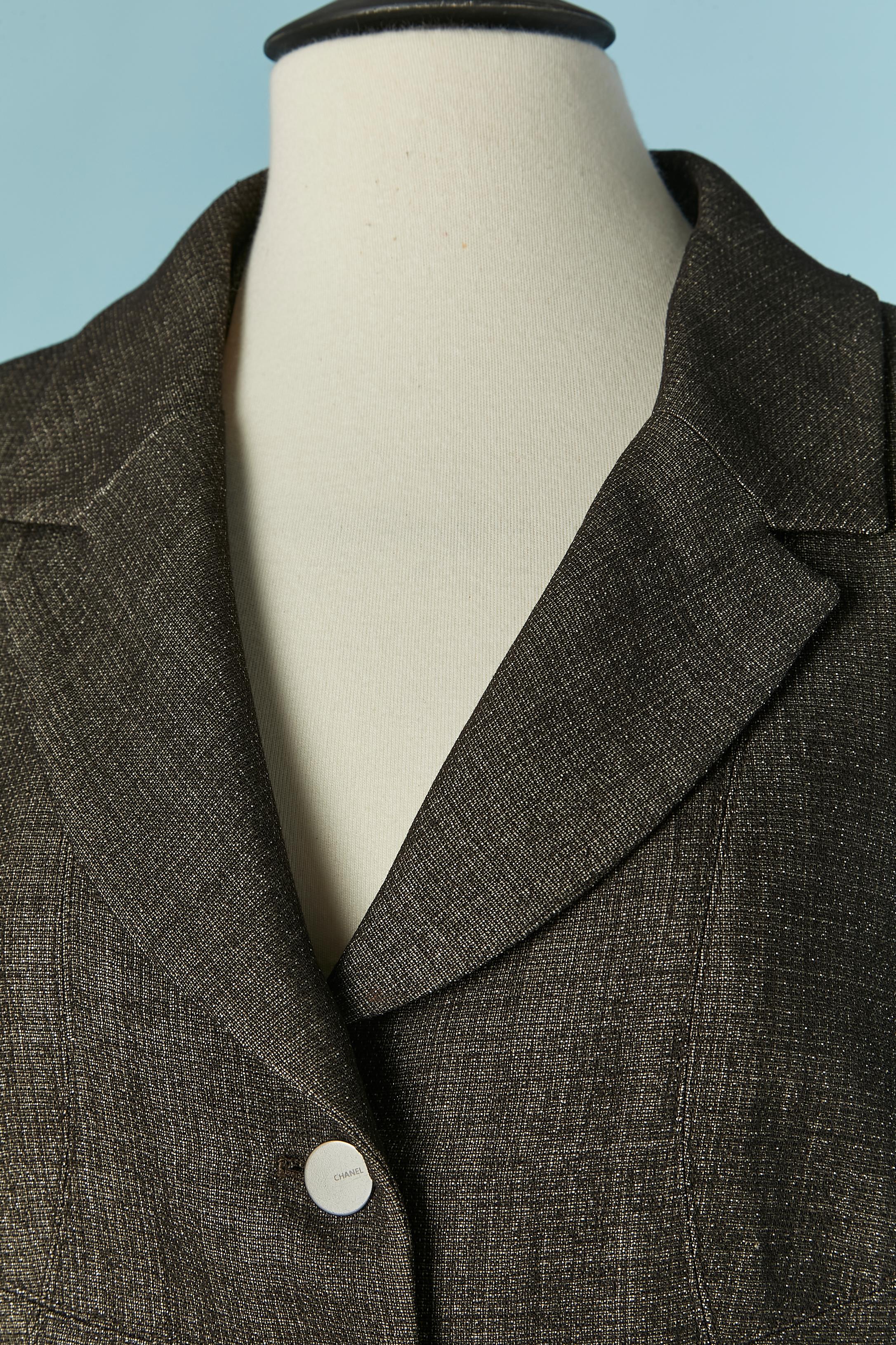 Grey wool single breasted jacket with lurex threads. Main fabric composition: 65% wool, 19% polyester, 10% nylon, 6% cotton. 
Silk branded lining. 
Thin shoulder pad. Branded button and buttonhole closure on the middle front. Cut-work. Pocket on