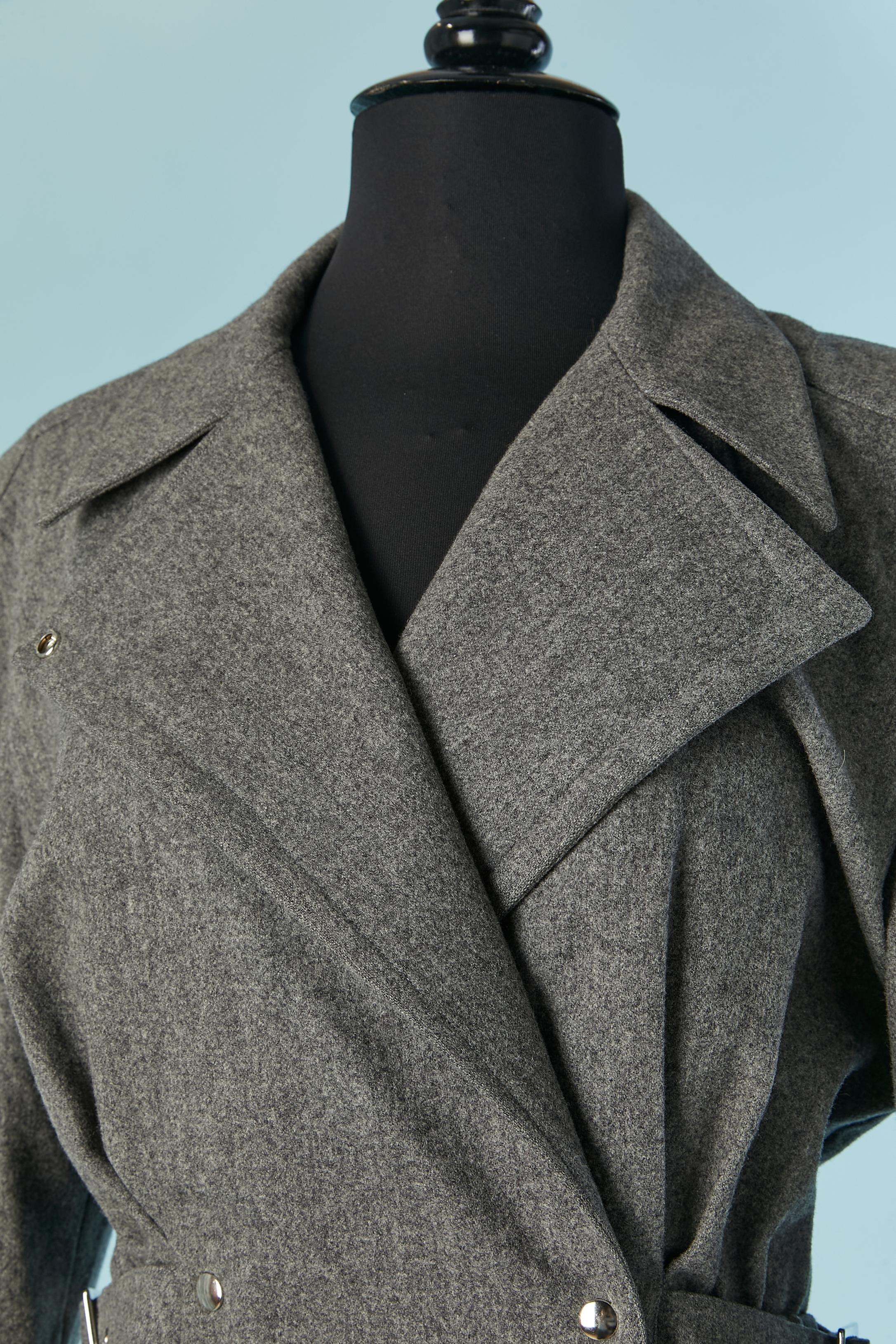 Grey wool skirt-suit. Rayon lining only inside the shoulders. 
Snap closure on the middle front + on cuffs. Half-belt on both side with buckle closure.Pocket on both side. Elastic waist on the waist. 
SIZE on tag 36 but the jacket fit M and the