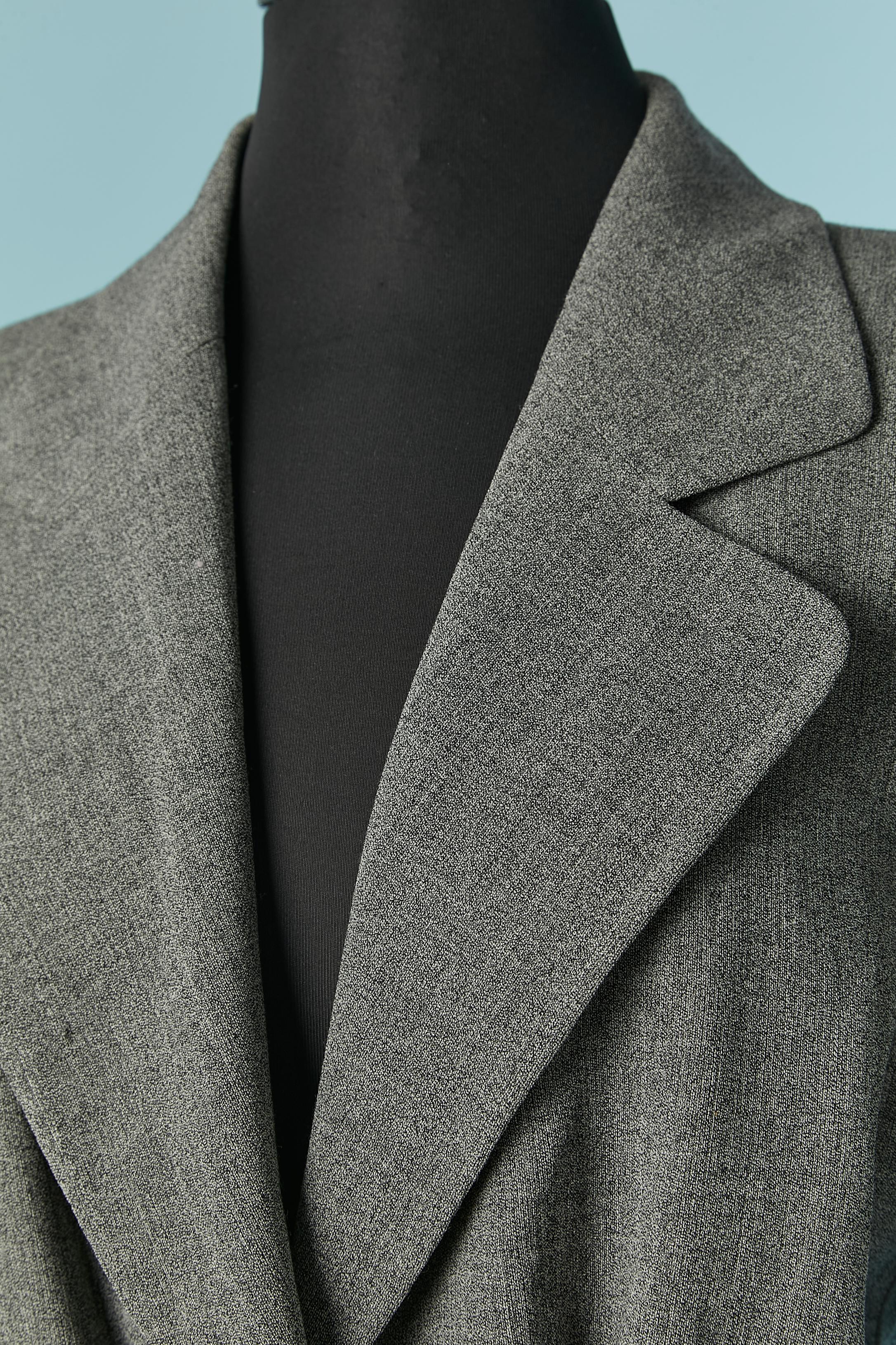 Grey worsted wool skirt suit . Lining composition: 63% acetate, 37% rayon.
Shoulder-pad. Button and buttonhole closure on the jacket + 1 extra button provided. Pocket on both side. 
SIZE 44 (It) 40 (Fr) 10 (US) L 
