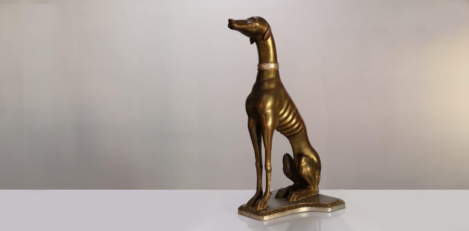 Spectacular Greyhound from the beginning of the 20th century, carved in wood with golden patina and stamped on the made in Italy base.

Condition: Good condition in general, to highlight a fissure in the left front leg. Also some wear or cracks in