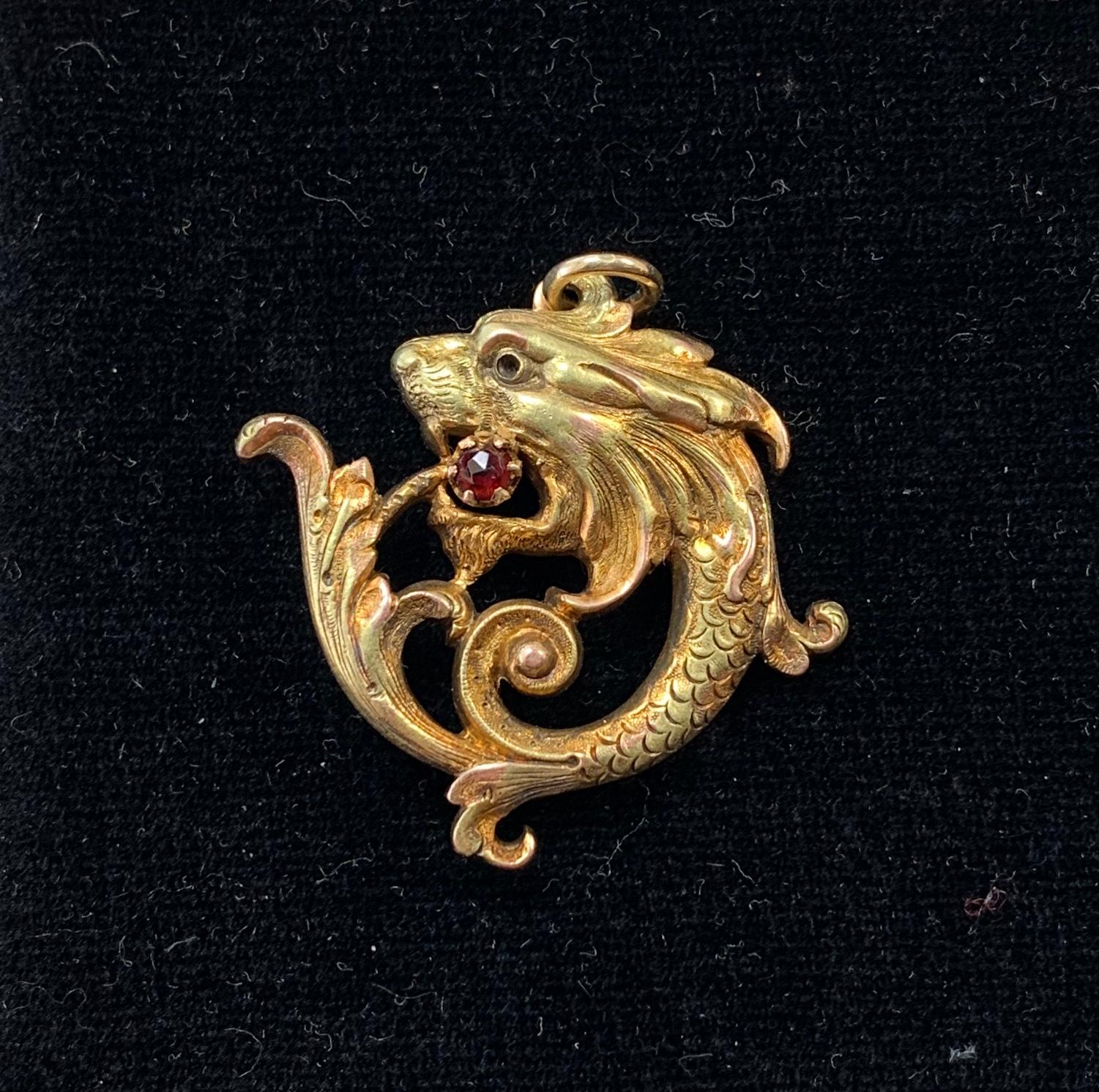 THIS IS A STUNNING BEAUX ARTS RENAISSANCE REVIVAL ART NOUVEAU 14 KARAT GOLD PENDANT OF A GRIFFIN OR DRAGON WITH A STUNNING ANTIQUE GARNET IN THE MOUTH.
This is a beautiful Beaux Arts - Art Nouveau - Belle Epoque pendant in the Renaissance Revival