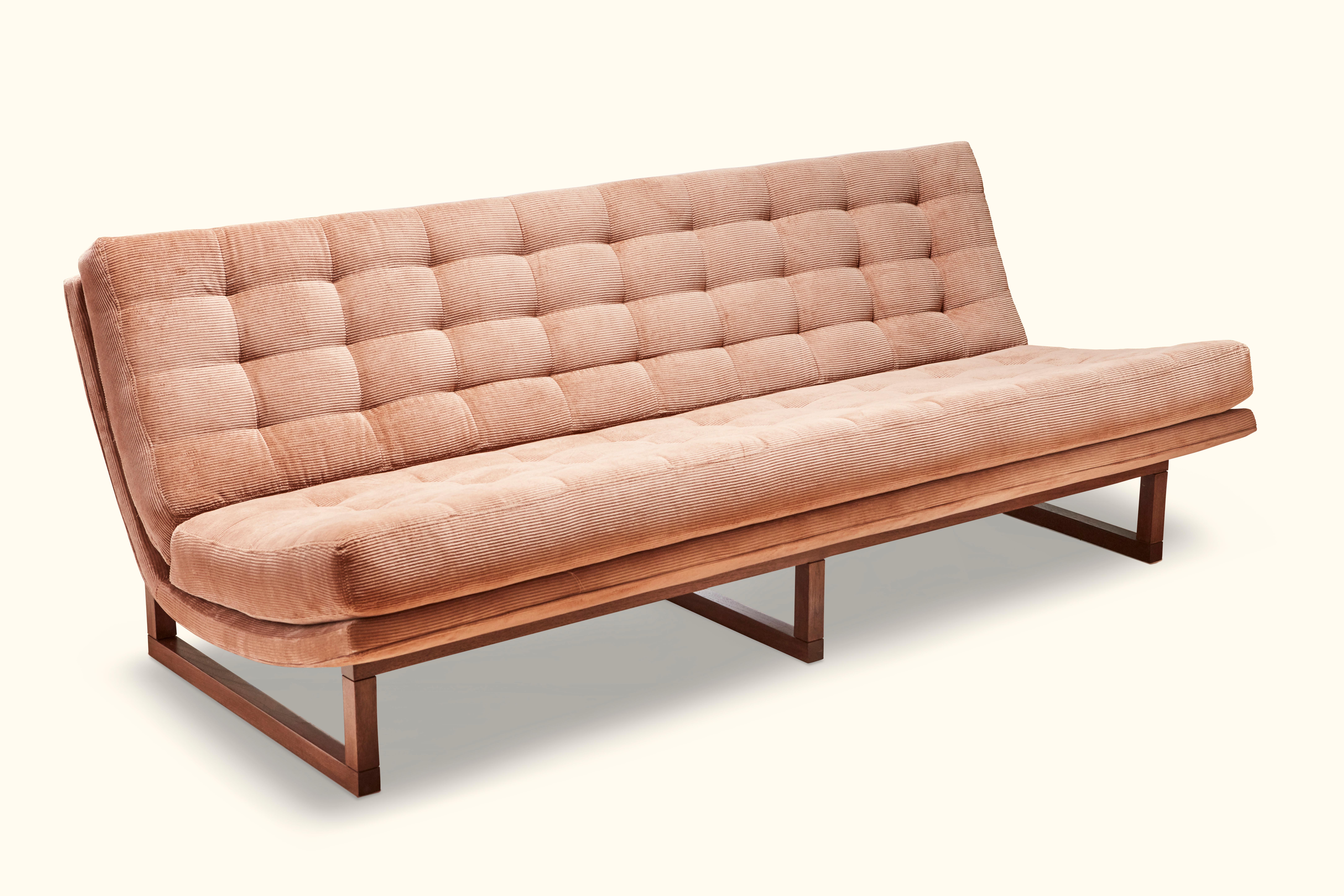 The Griffin sofa is a wide, armless lounge sofa that features biscuit tufting with no buttons. Frame available in American walnut or white oak.
