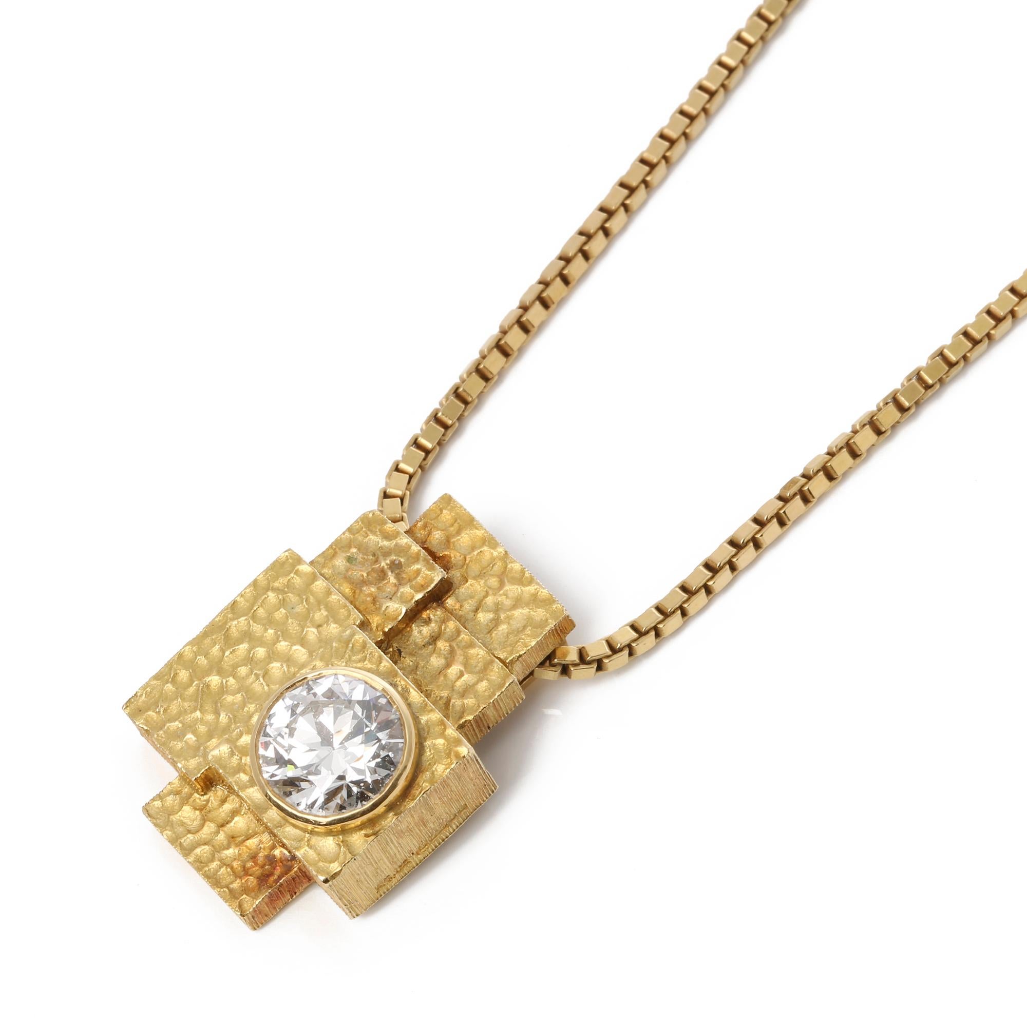 This pendant by Grima dates from 1986 and is a bespoke piece that was designed for its previous owner to showcase the heriloom diamond. The 2.18ct diamond is set within an 18ct gold abstract mount with a signature textured finish and finished with