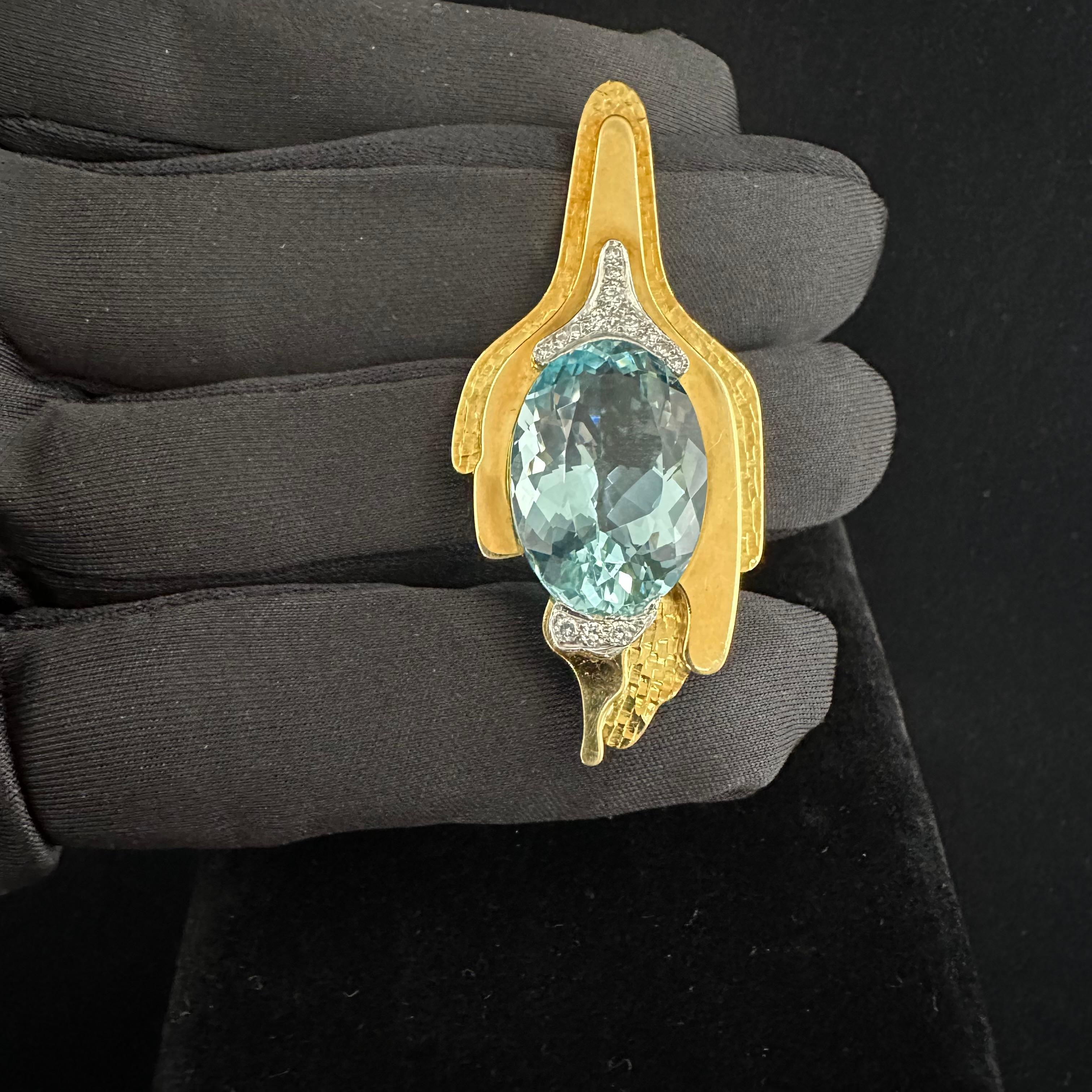 Andrew Grima
Known as the doyen of modern jewelry design. 
Up for Sale   
A Large Oval Aquamarine set in 18k Yellow Gold approx 10Ct Aqua.
Length 2.25 Inches by 1 inch Width
14 Round Diamonds 
Beautiful Textured Gold contoured to a highly polished