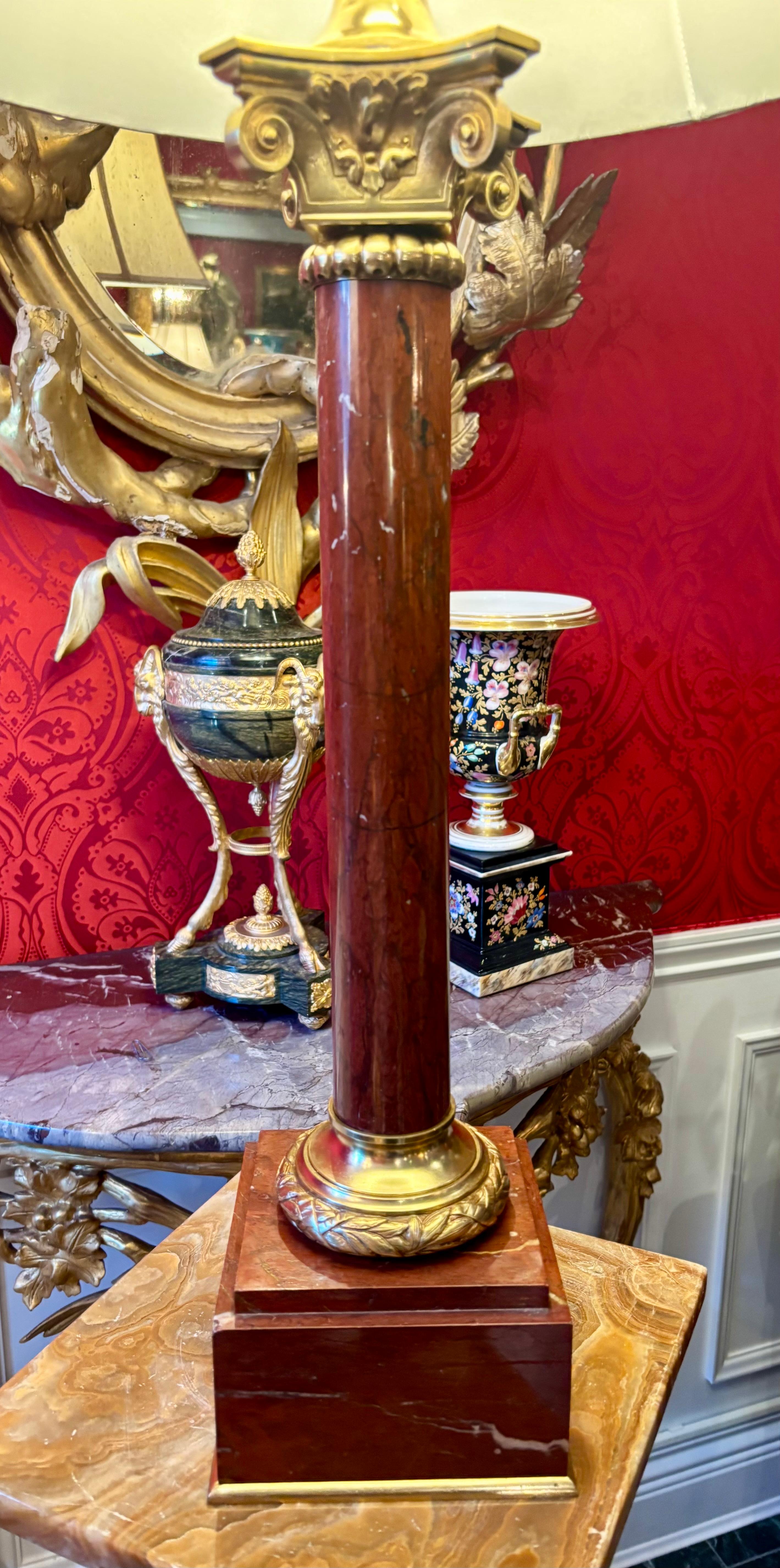 A rare  late 19 Century griotte marble neo-classical column lamp with a a gilt bronze capital and a laurel wreath bronze base set on a square marble base with gilt bronze trim.