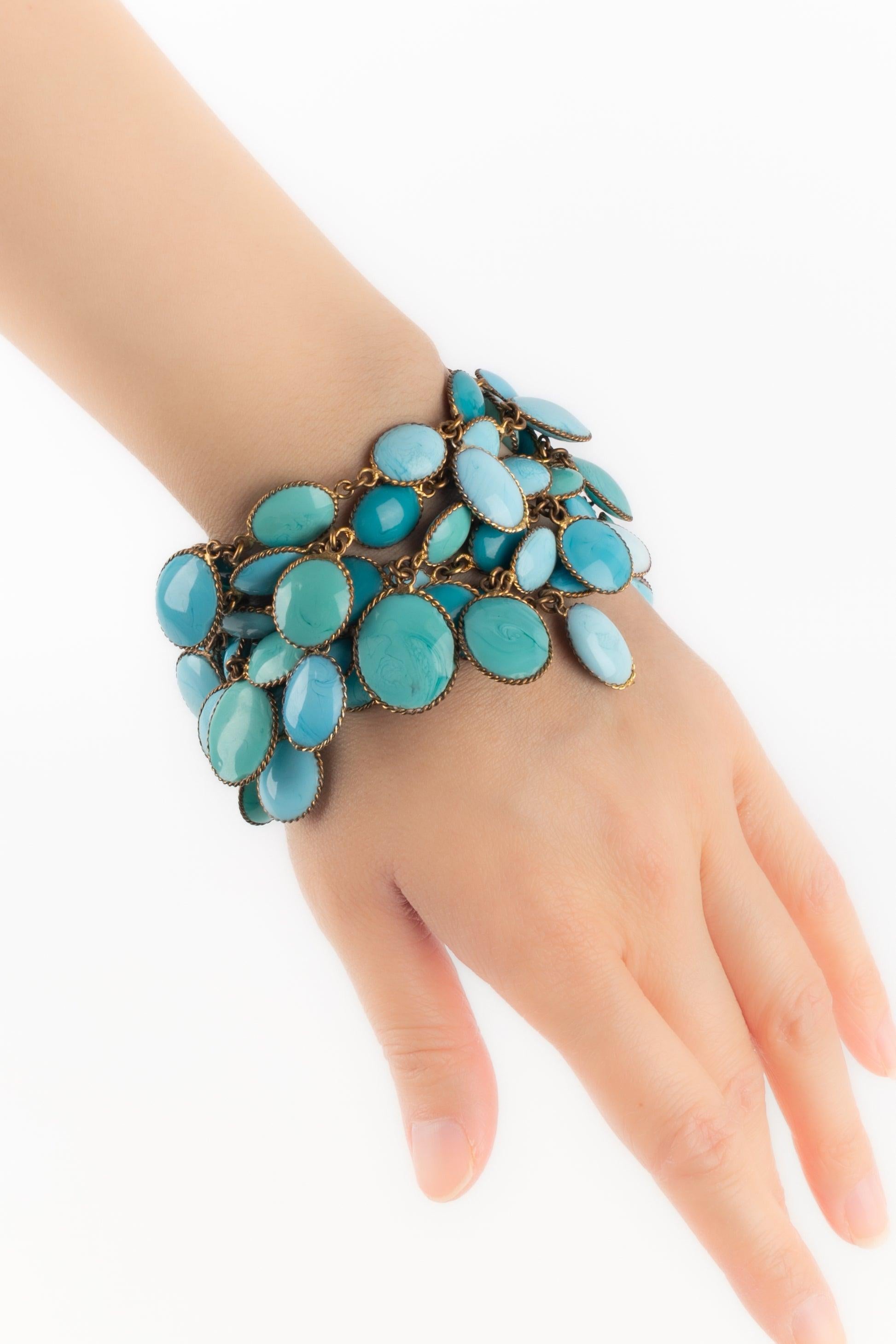Gripoix - (Made in France) Bracciale a più file in metallo dorato con nappe in pasta di vetro blu.

Informazioni aggiuntive:
Condizioni: Buone condizioni
Dimensioni: Lunghezza: 19 cm

Riferimento del venditore: BRA12