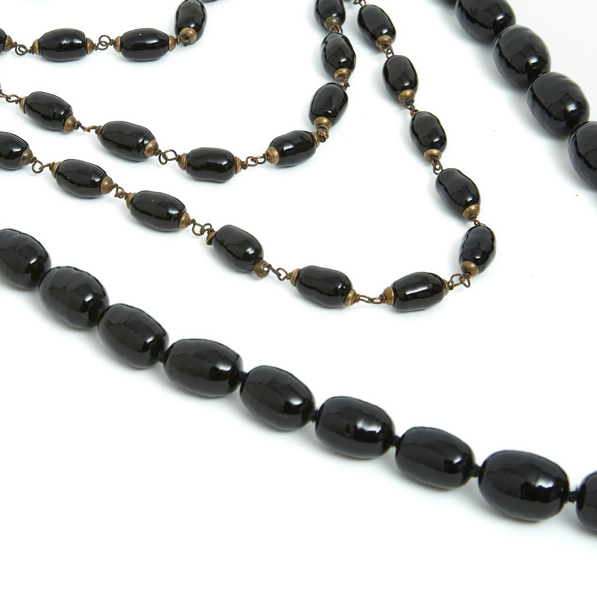 Gripoix set of 2 long necklaces in black glass beads and gold metal, the first long necklace made up of small oval-shaped beads mounted on metal wire, total length (closed) 152 cm (!!!), dimensions of a bead approx. 1.3 x 0.95 cm, the second made up