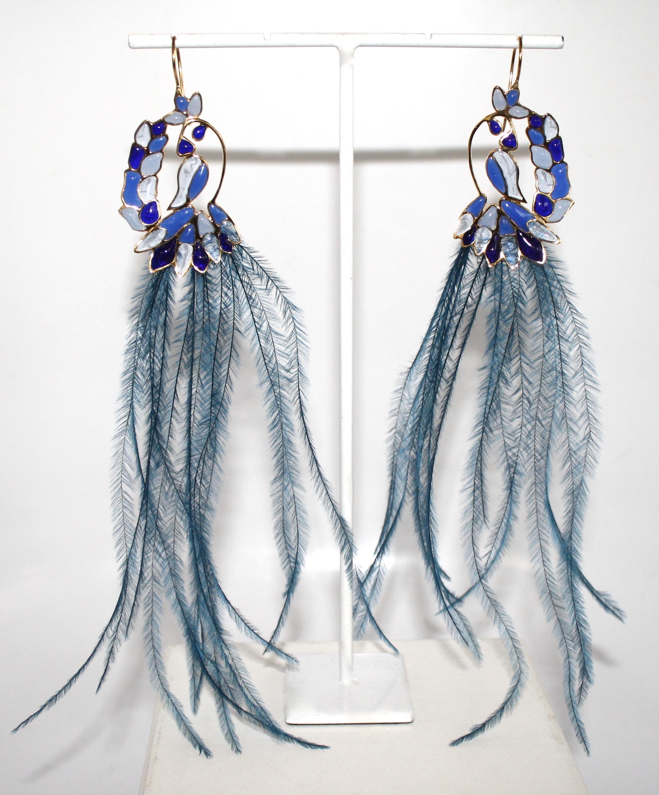 Poured glass pierced earrings with blue feathers from Gripoix. 