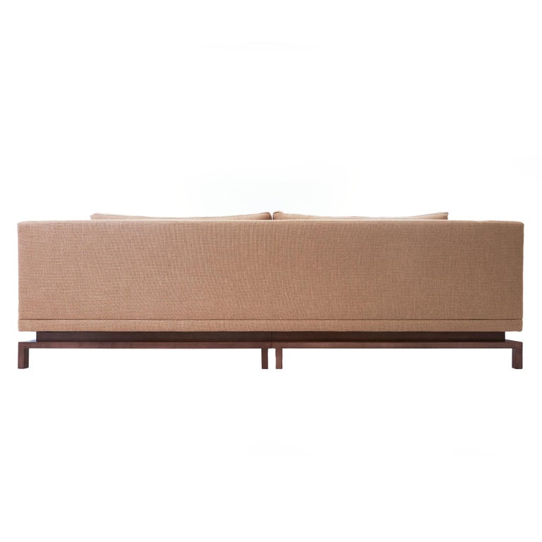 The Gil Melott BESPOKE Flotar Custom Sofa is a sleek contemporary piece that is classic yet still decidedly modern. Broad upholstered cushions are flanked with wide arms, yet delicately balanced on a solid plinth base, giving the illusion of