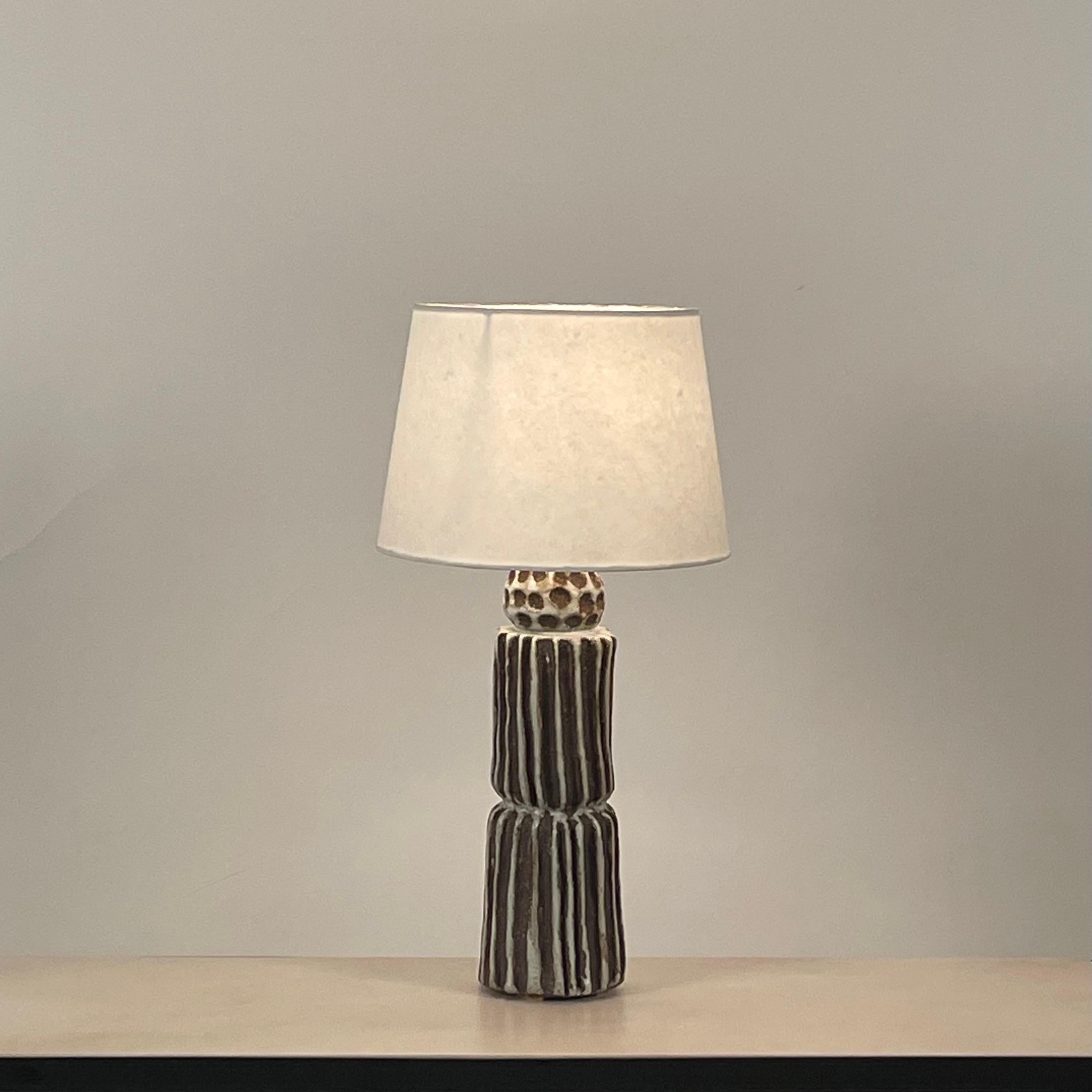 Grooved Pottery tall 'Sillons' lamp with parchment shade by Design Freres.

Attractive Euro style shade with no finial. Wired with twist cord and 3-way switch.

Dimensions listed are the overall dimensions of the lamp with the shade, as