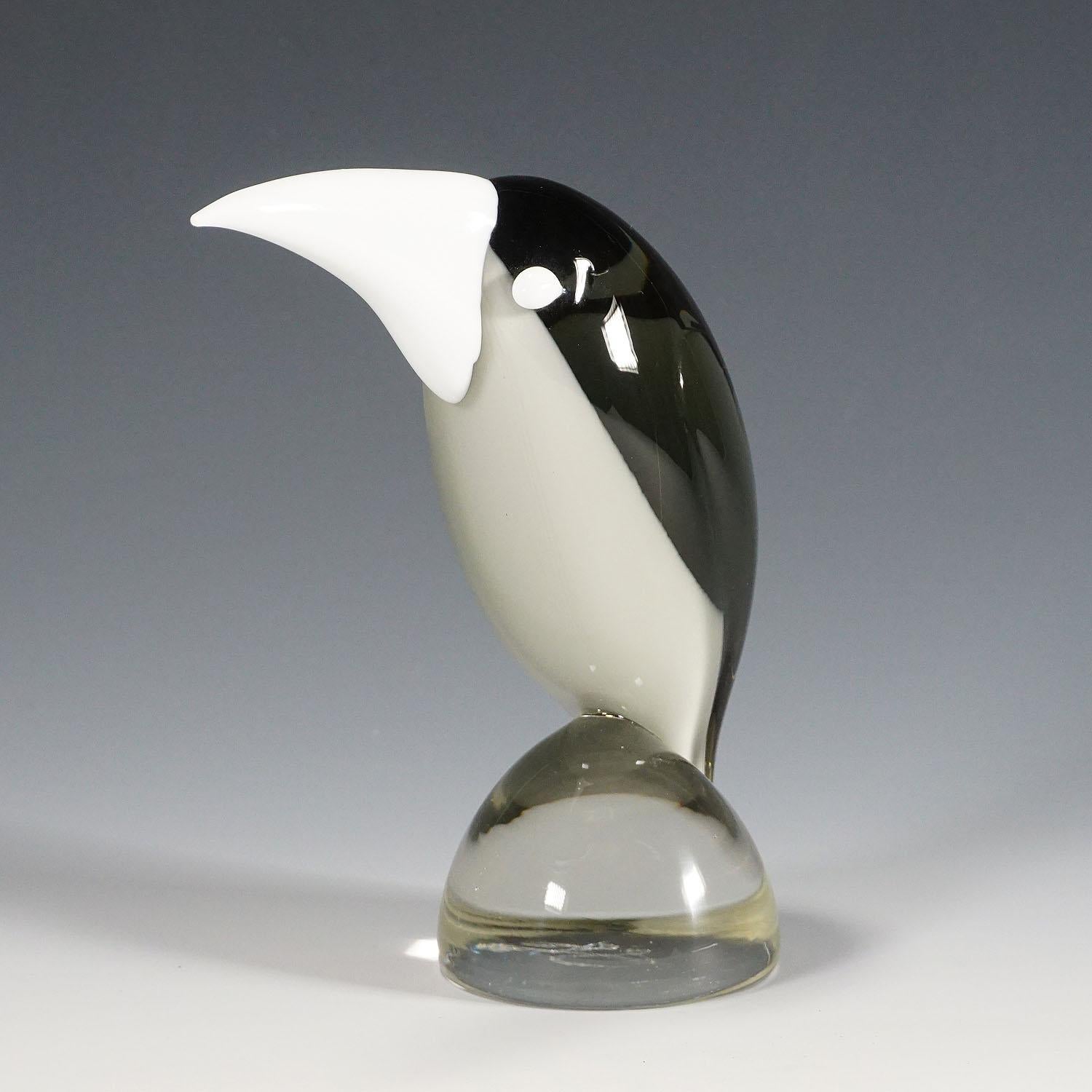 A sculpture of a stylized grosbeak in smoke grey and opaque glass. It is hand made in the Gral glass manufactory, Germany. Designed by Livio Seguso, ca. 1970. Incised signature of the artist (LS) on the base.

Livio Seguso (* 1930) comes from a