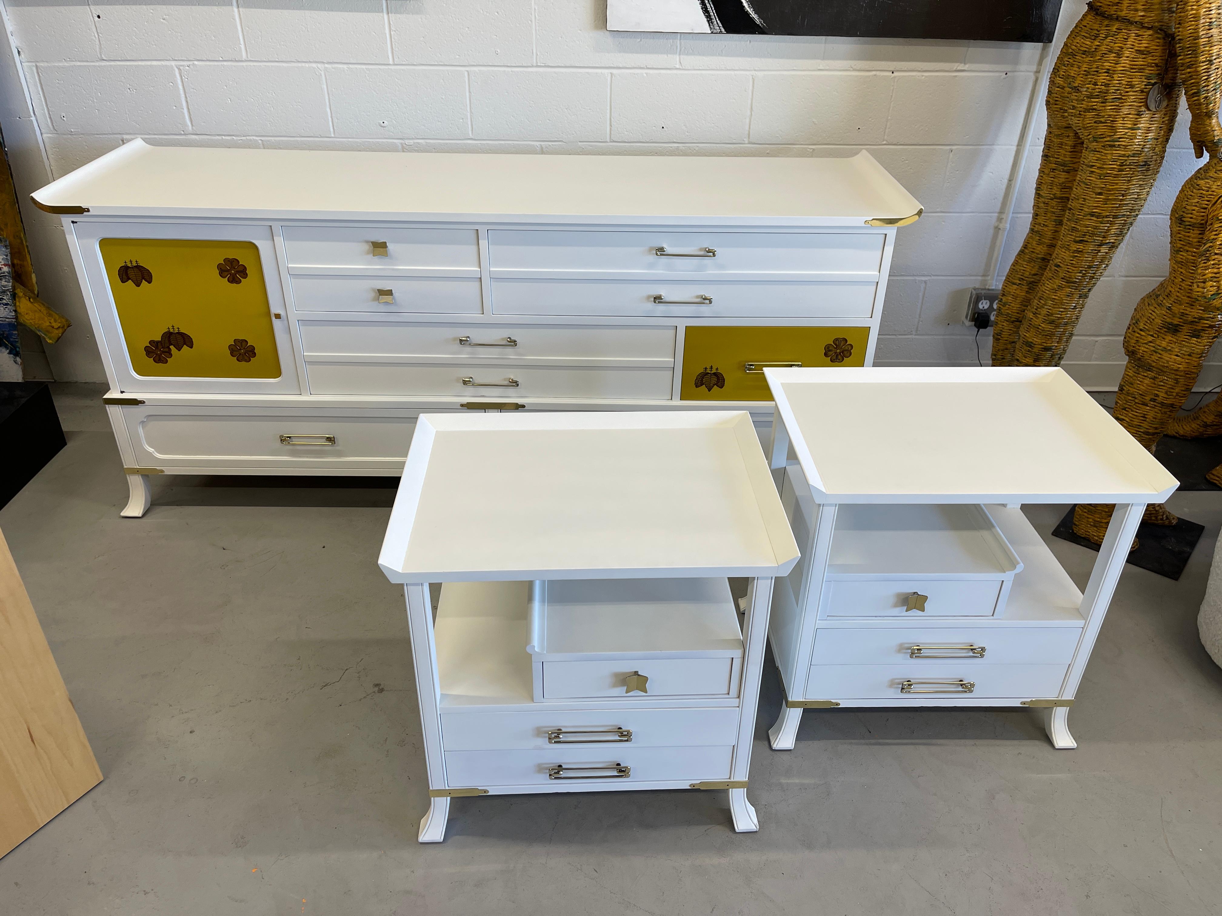 Beautiful Grosfeld House 3 piece painted bedroom set with brass accents. Elegant Hollywood Regency styling. Lovely yellow painted original doors on the long dresser. We’ve had the set repainted a nice white. Hardware has been polished. Each of the
