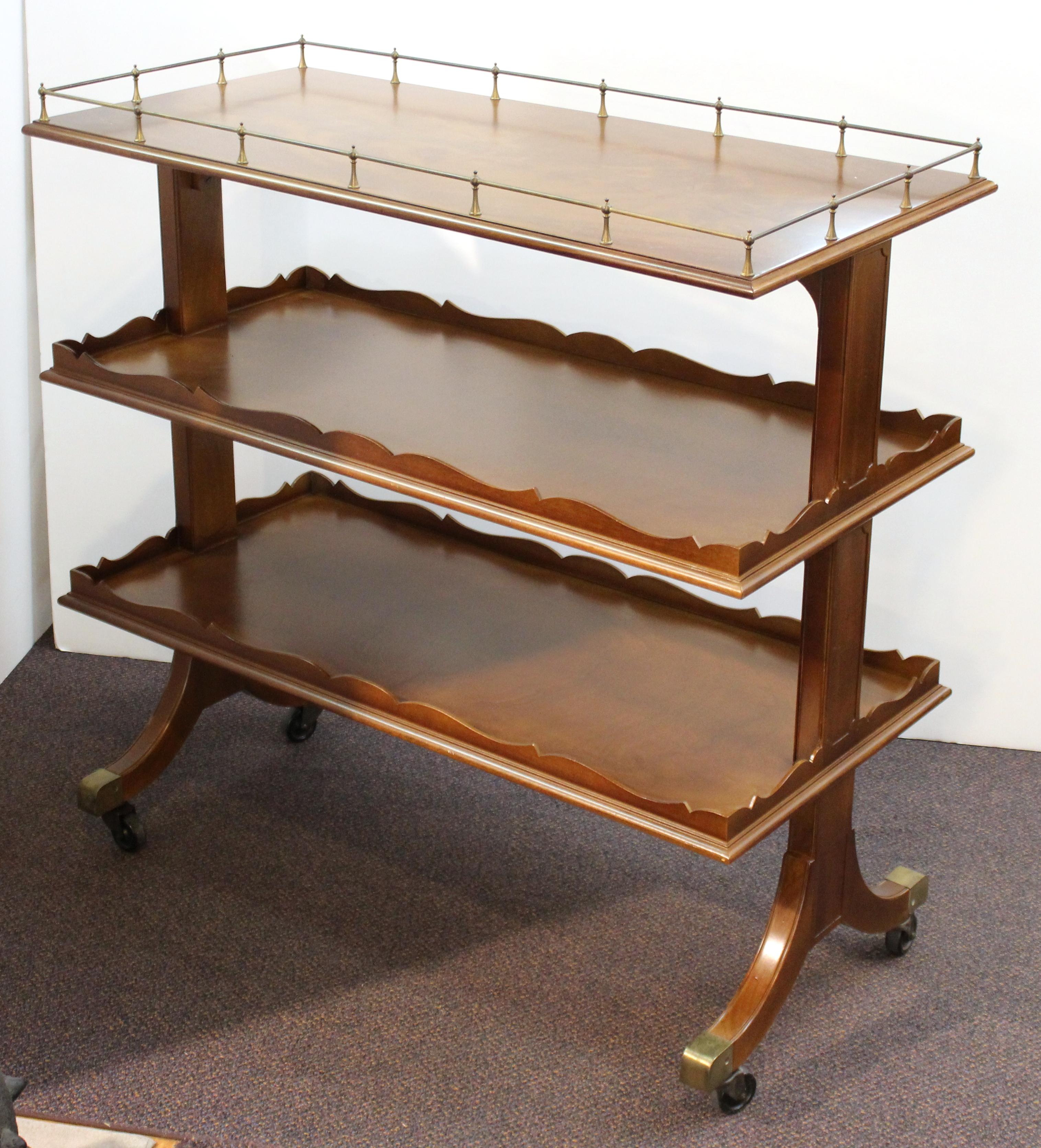 American Art Deco mahogany serving cart or bar cart designed by Grosfeld House during the 1940s. The cart has three tiers, stands on wheels and has been recently restored.