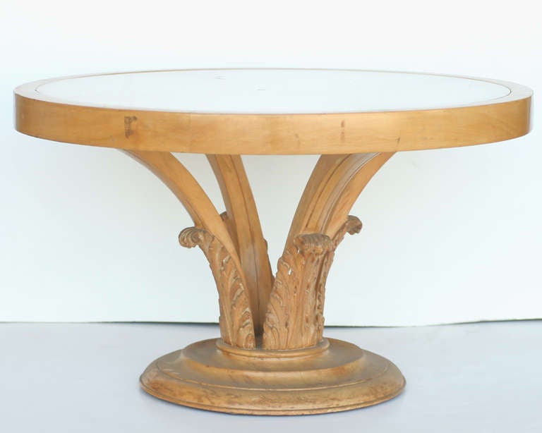 Carved wood palm leaf coffee table with highly detailed carved accents and trim with a frosted white plate glass tabletop,

circa 1940.