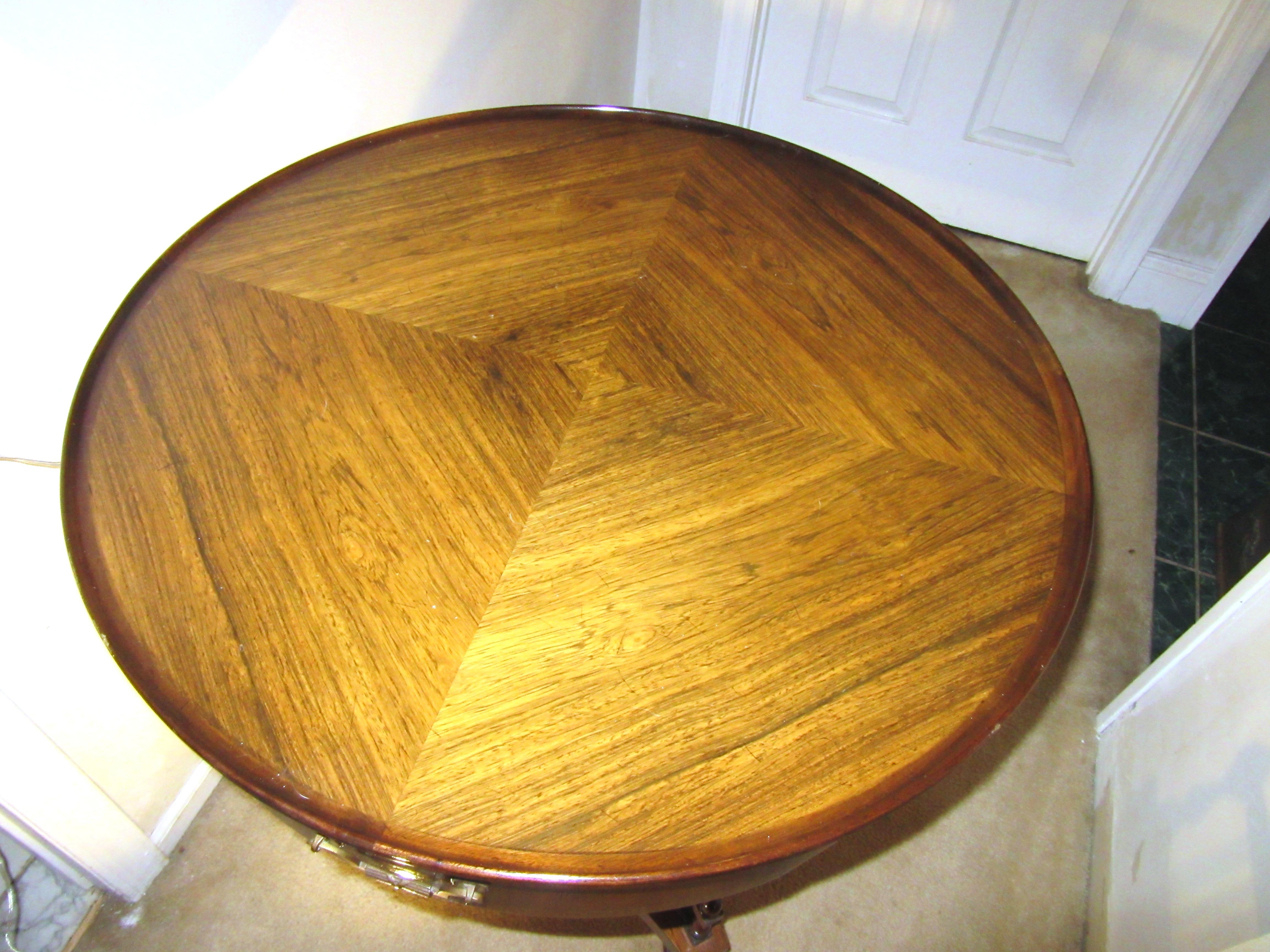 Art Deco round rosewood drum table made during the 1940s by Grosfeld House. The table has a gallery on the bottom of the pedestal and bookmatched rosewood. Grosfeld House label in the center drawer. In great vintage condition with some scratches on
