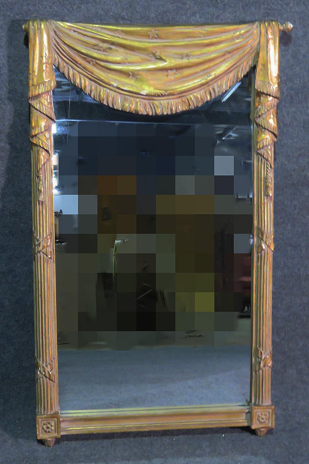 This is a gorgeous gilded mirror made by Grosfeld House of New York. Designed in the Hollywood Regency style, this mirror is gilded and imaginative. Measures: 45 1/2