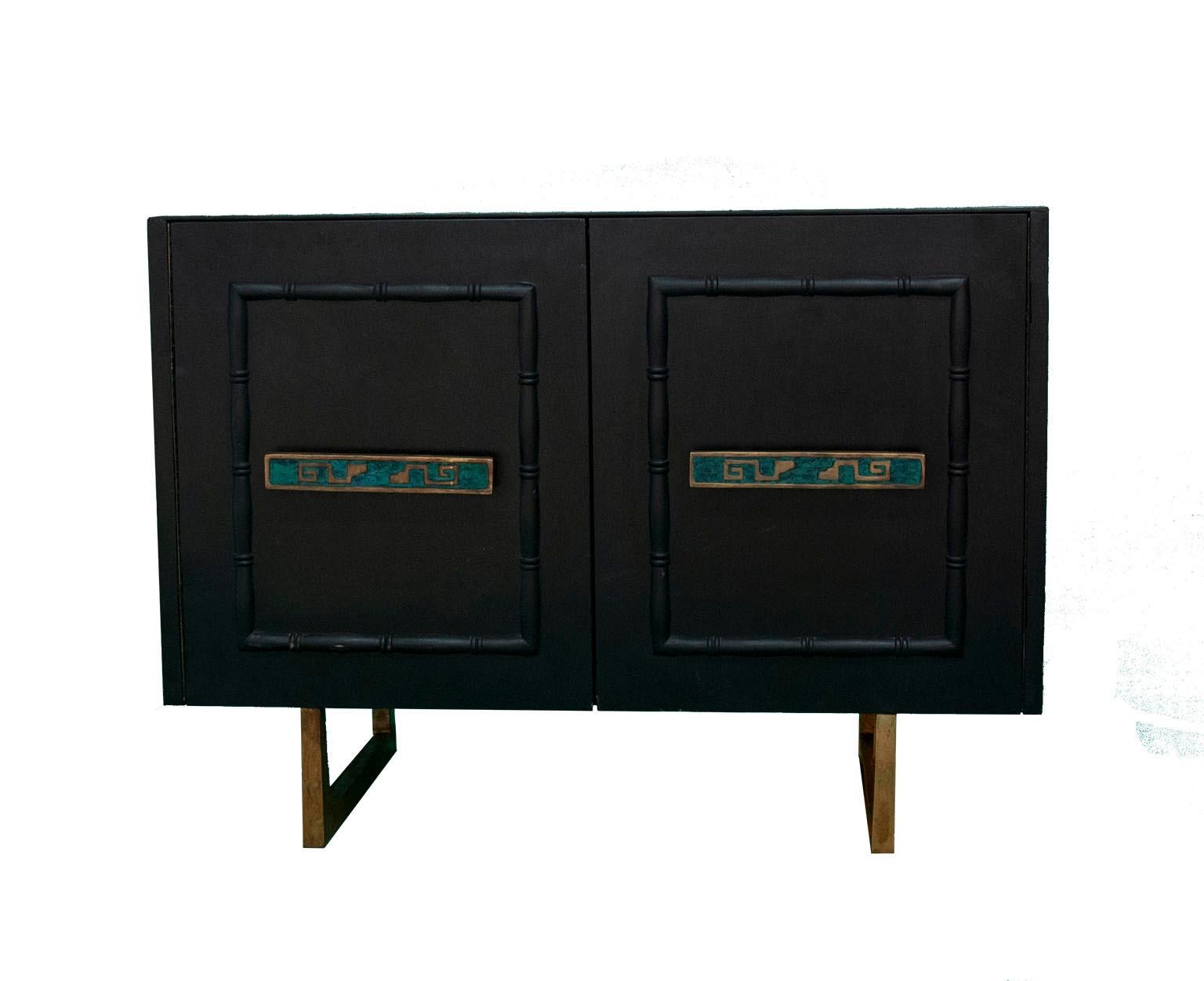 Ebonized mahogany cabinet finished in matte black, with bronze pulls from Pepe Mendoza with blue and green enamel.
The legs are made of bronze in natural finish.