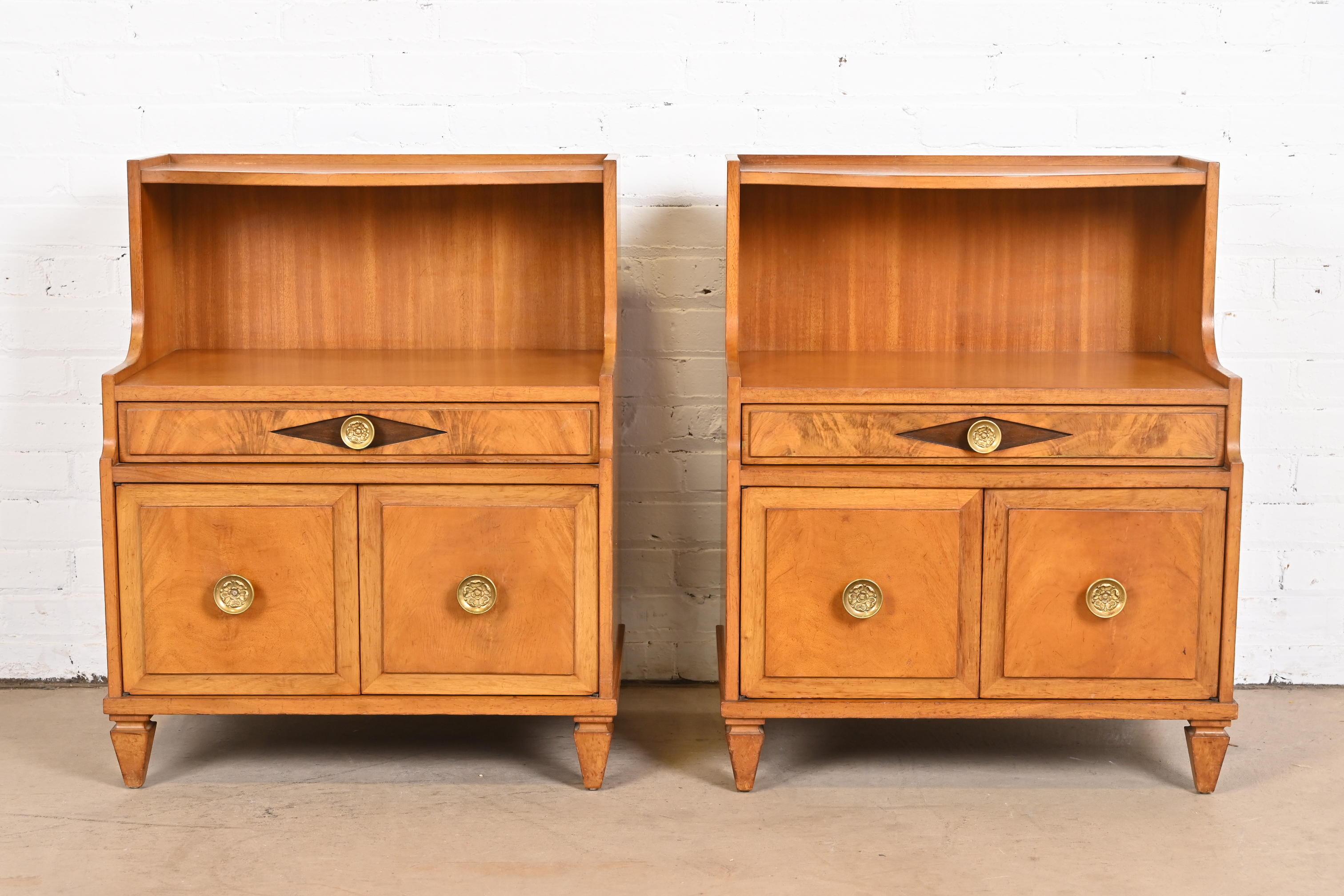 A gorgeous pair of Hollywood Regency or neoclassical nightstands or end tables

By Grosfeld House

USA, Mid-20th Century

Mahogany, with beautiful flame mahogany fronts and original brass hardware.

Measures: 24.38