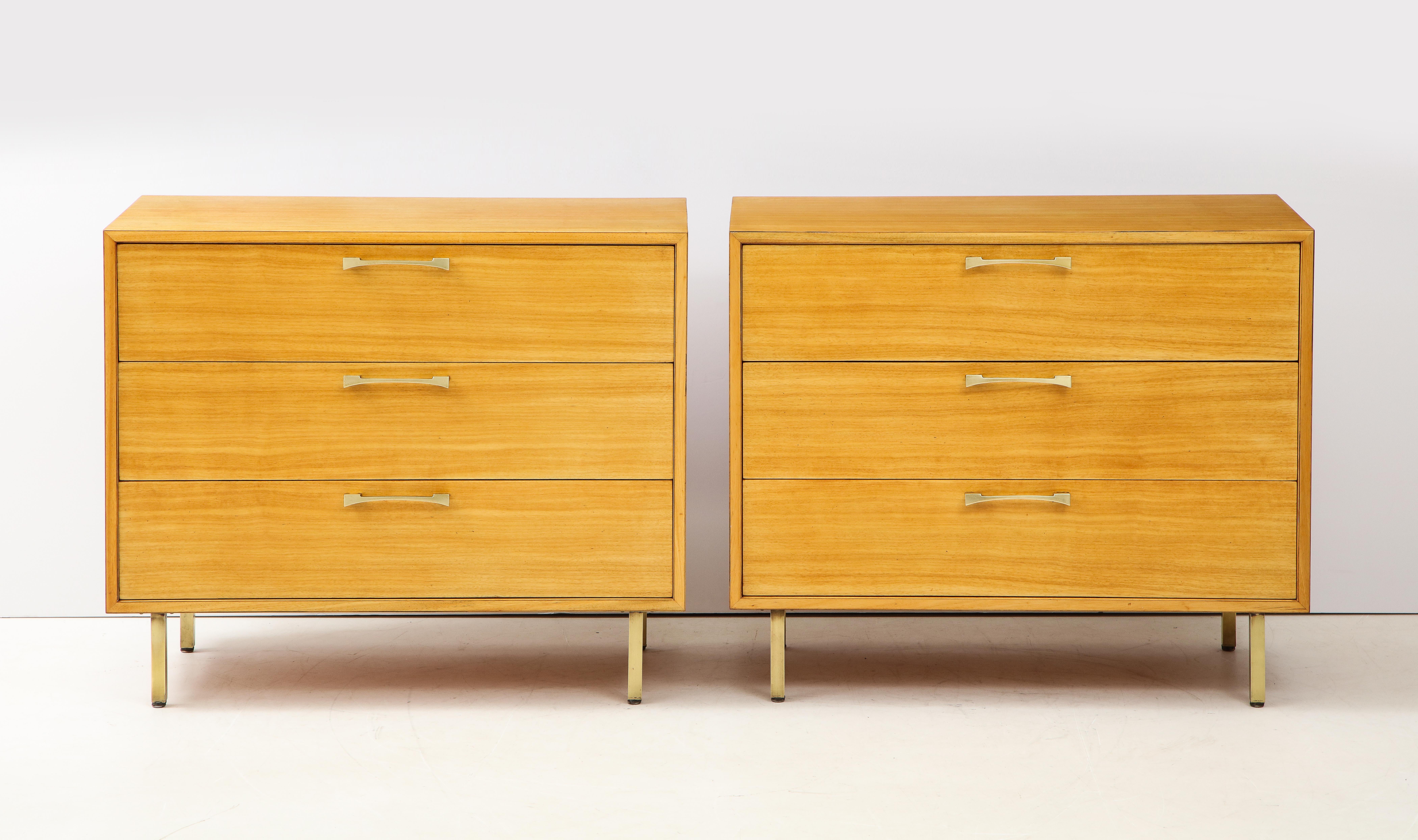 Stunning pair of 1950s 3-drawer dressers by Grosfeld House well made and very solid made of Primavera wood with solid brass handles and legs, lightly restored with minor wear and patina.