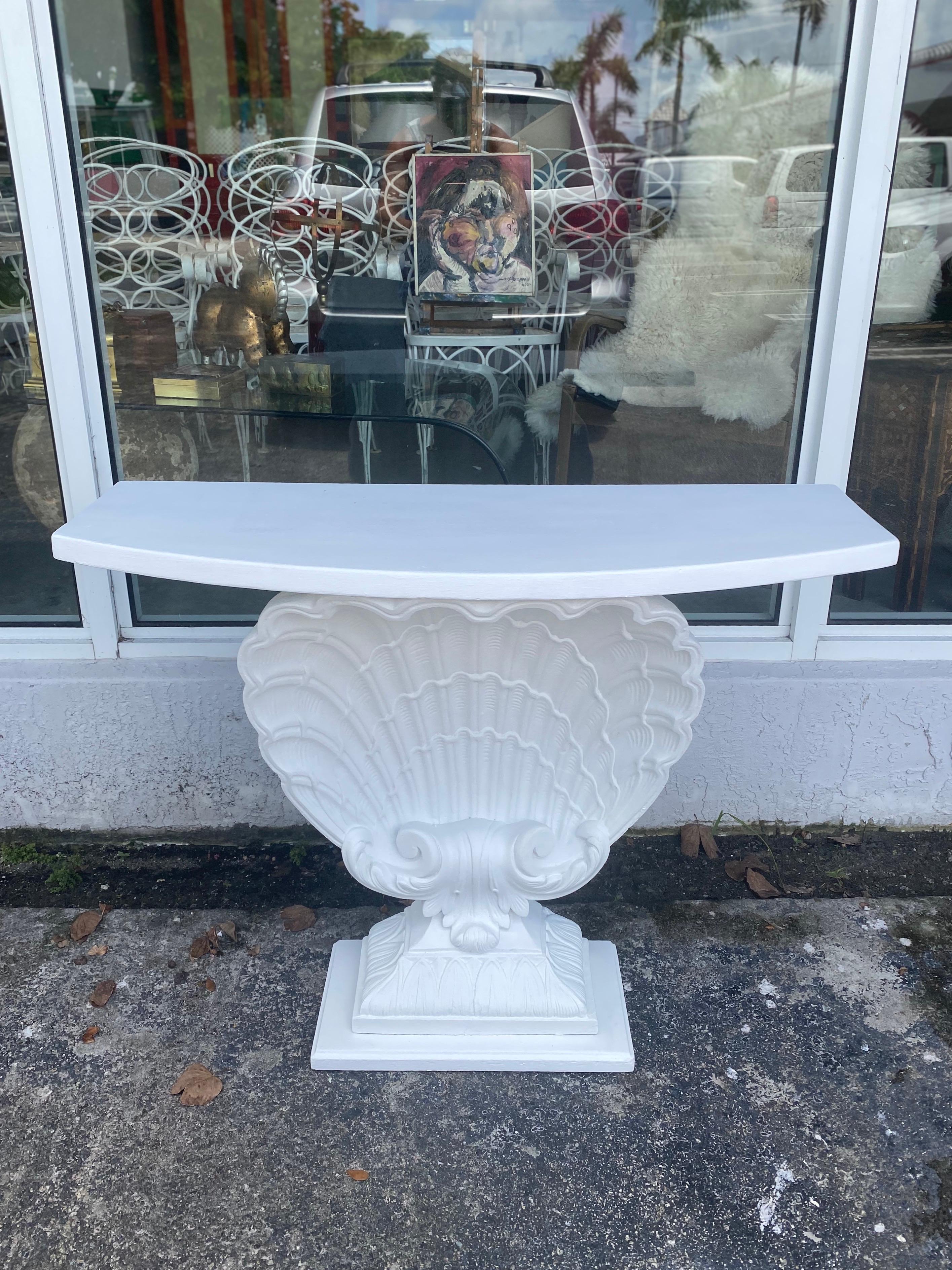 A beautifully restored of classic Hollywood Regency shell-form console by Grosfeld House. Newly painted in plaster white with a super flat finish.