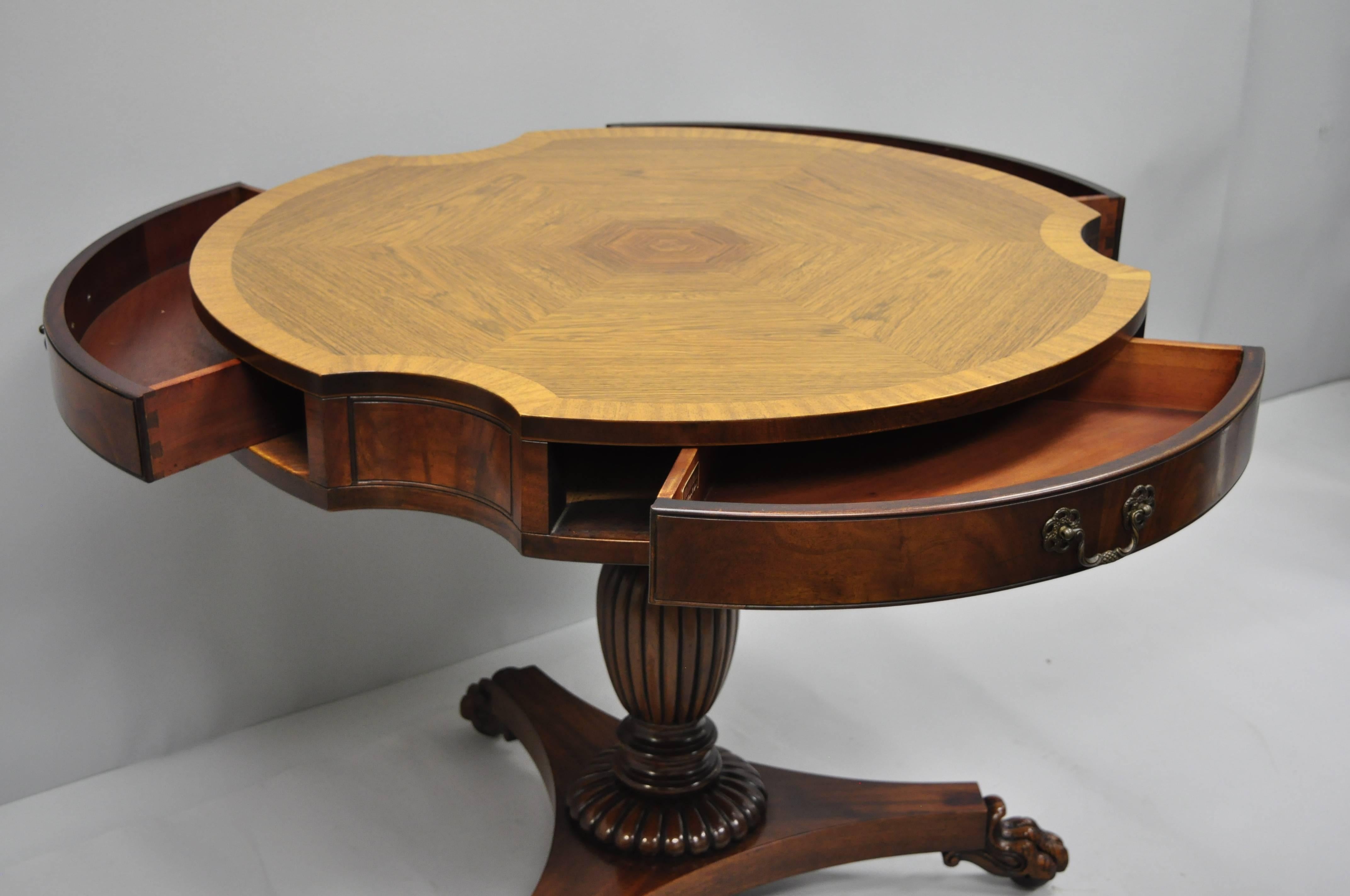 Grosfeld House mahogany and rosewood empire style three-drawer pedestal drum table with claw feet. Item features shaped banded rosewood top, paw foot tripod pedestal base, beautiful wood grain, original label, 3 dovetailed drawers, quality American