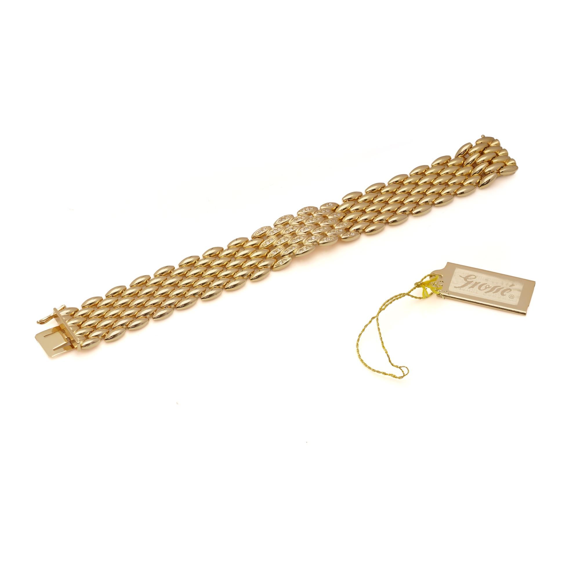 A vintage Grosse for Dior bracelet, crafted in gold-plated metal. The design features four rows of oval links with a central section of marquise-shaped motifs, each set with sparkling clear crystals. The wide panel construction gives the bracelet a