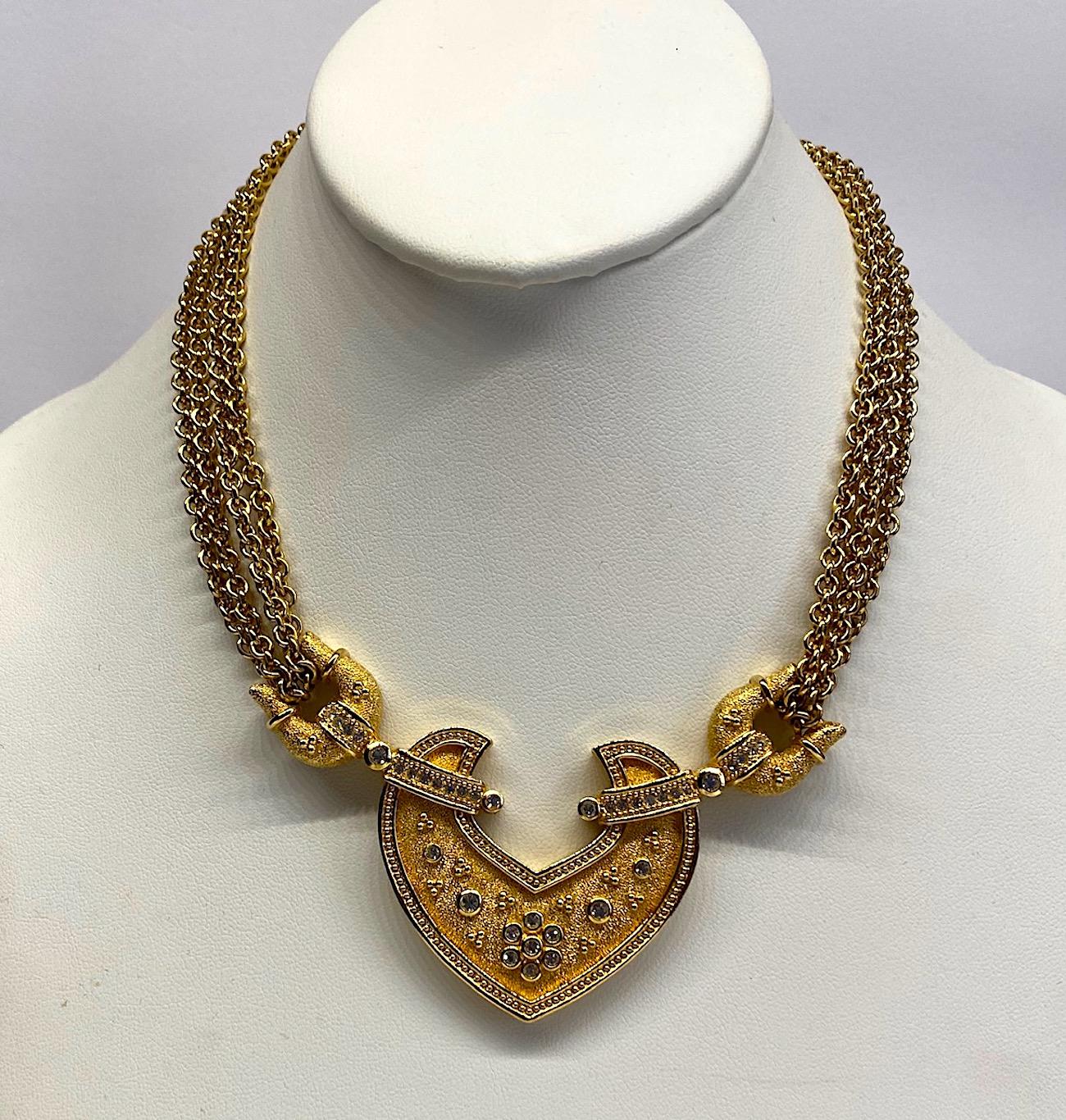 A beautiful multi chain with central pendant 1980s necklace by German company Grosse. Two strands on each side descend from the back clasp down, wrap around the side pieces of the pendant and return up to the clasp. The chains, and clasp are in