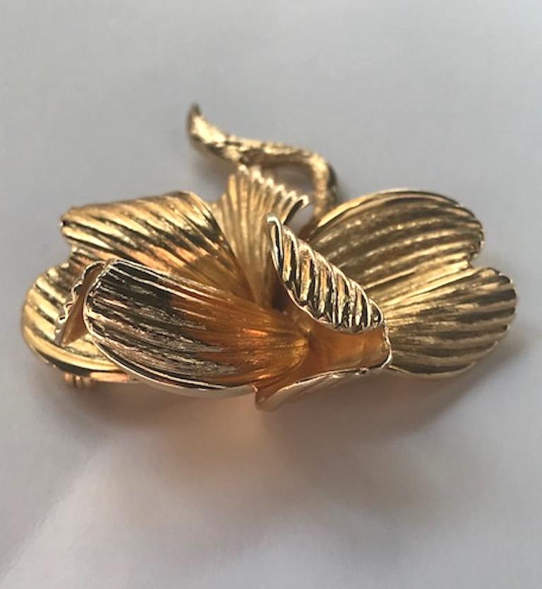 A beautifully crafted three dimensional flower brooch from 1962 by German jewelry company Grosse. Five ribbed texture petals are curled and attached to a carved brach. The brooch measures 2 inches wide, 2.5 inches long and 1 inch deep. The back has