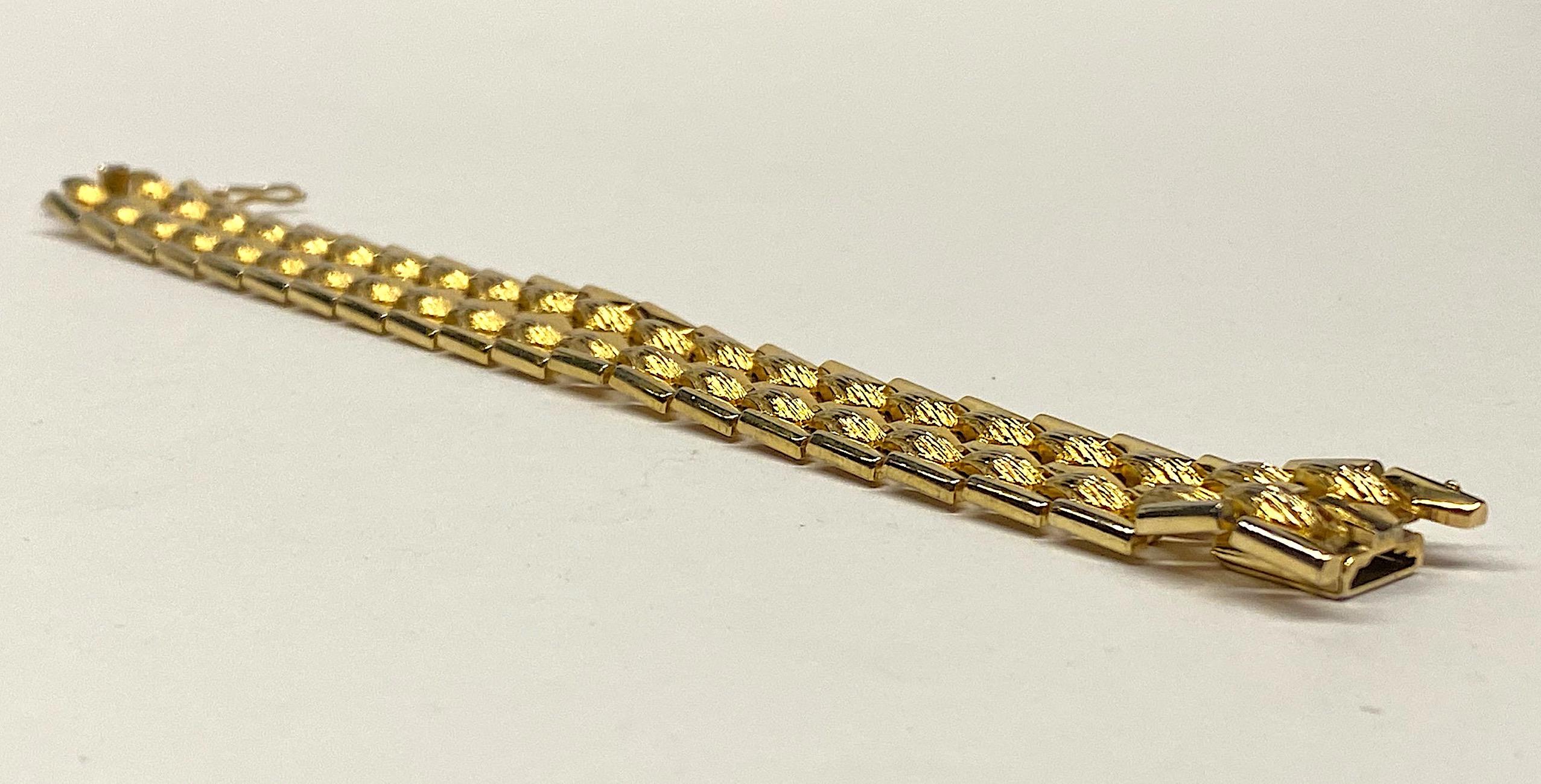 A classic style link bracelet by German manufacturer Grosse' from 1958. The elongated honeycomb design is executed in alternating rows of shiny and textured gold plate. It measures .82 of an inch wide and 7.88 inches long laid flat with a wearable