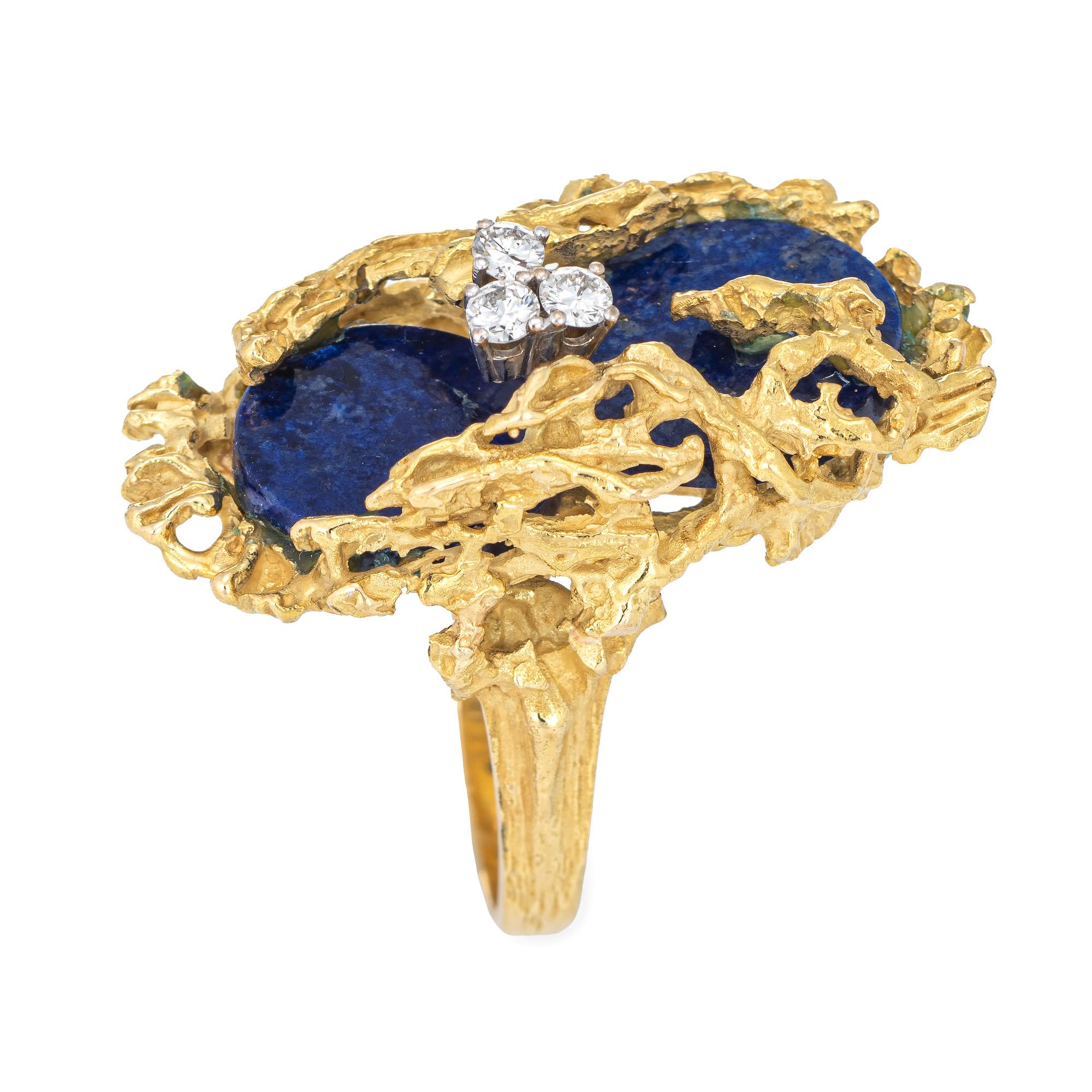 Stylish vintage Grosse Germany lapis lazuli & diamond cocktail ring (circa 1972) crafted in 18 karat yellow gold. 

Two round cut pieces of lapis lazuli measures 13mm each, accented with three estimated 0.05 carat diamonds. The total diamond weight
