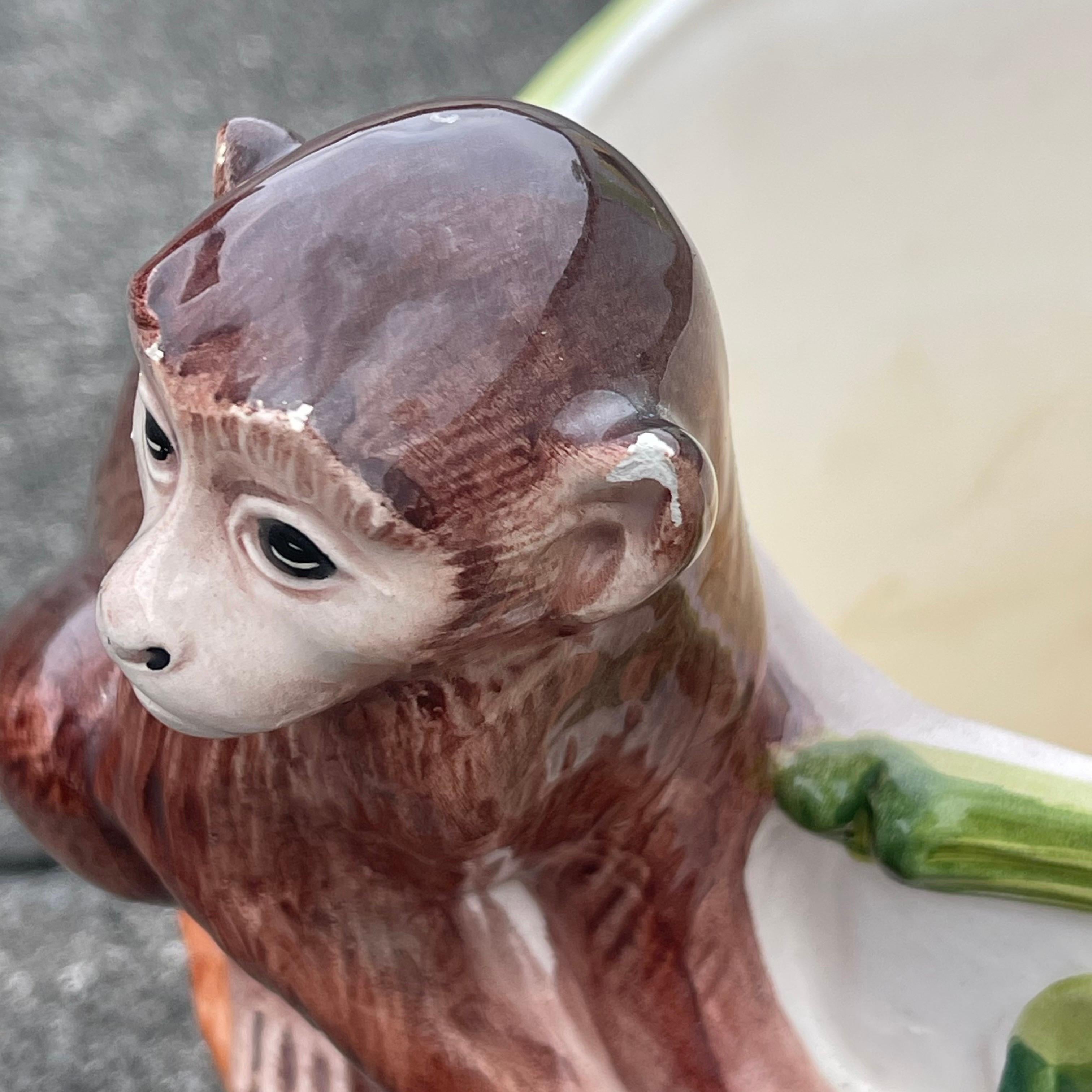 Charming hand painted planter featuring a monkey on a branch, with faux bamboo accents.