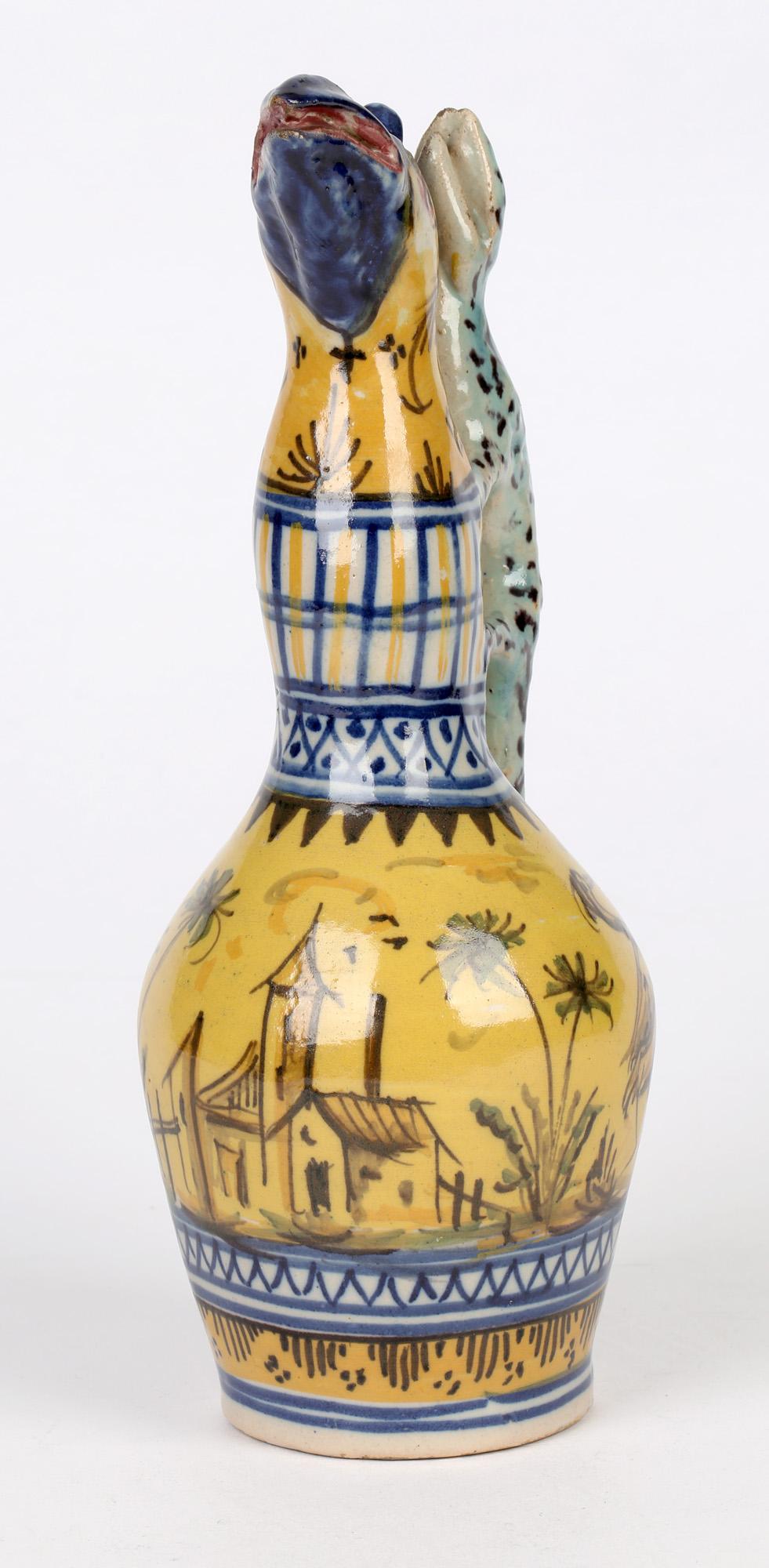 An unusual antique Spanish faience grotesque lizard handled pottery oil bottle dating from the 19th century. Possibly Alcora the bottle stands on a narrow rounded and unglazed foot with a shaped neck and an unusual bird form head to the top with a