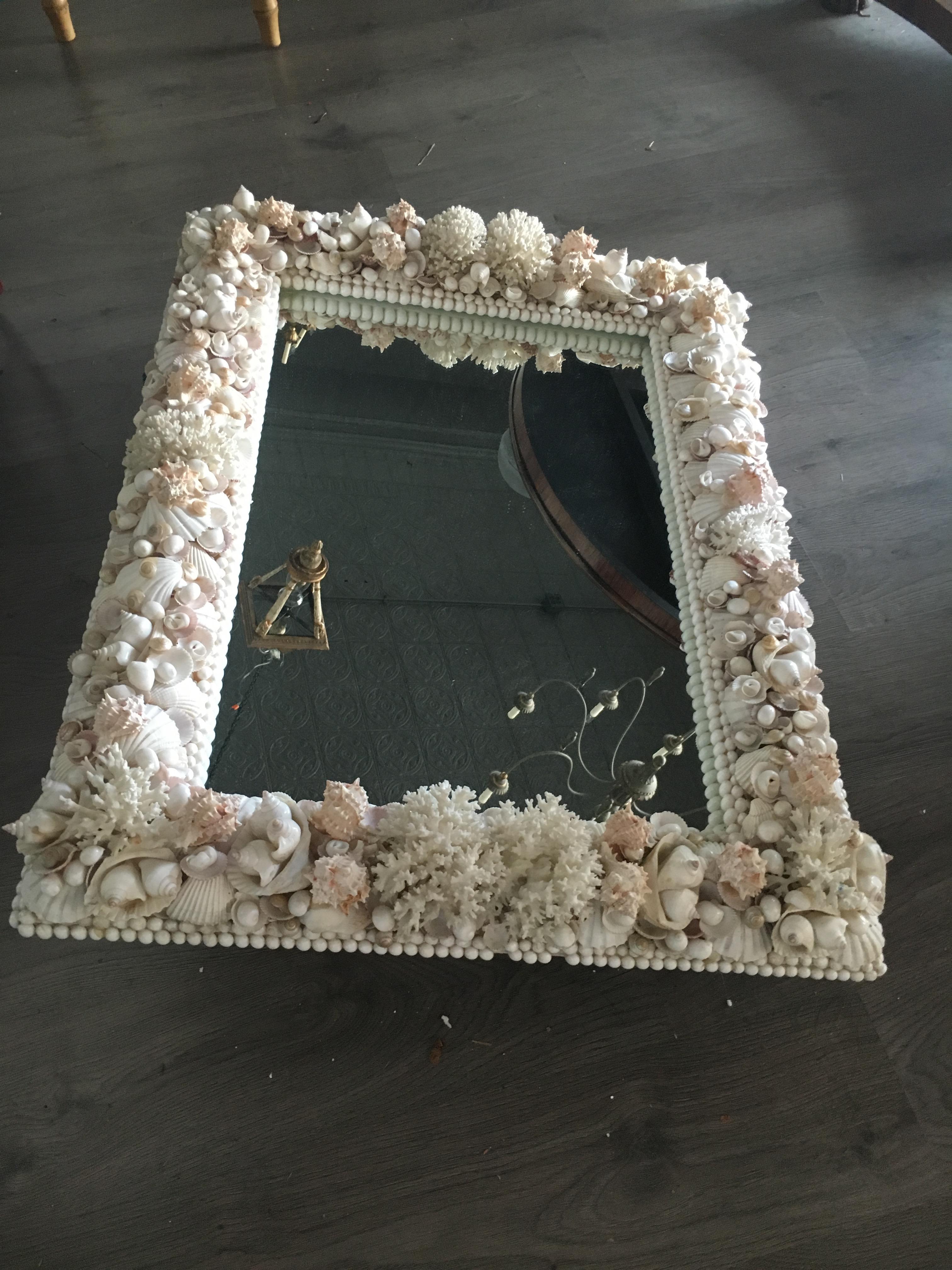 A Grotto style shell decorated mirror. Measures: Height 40 x width 30 inches. Great composition and detail.