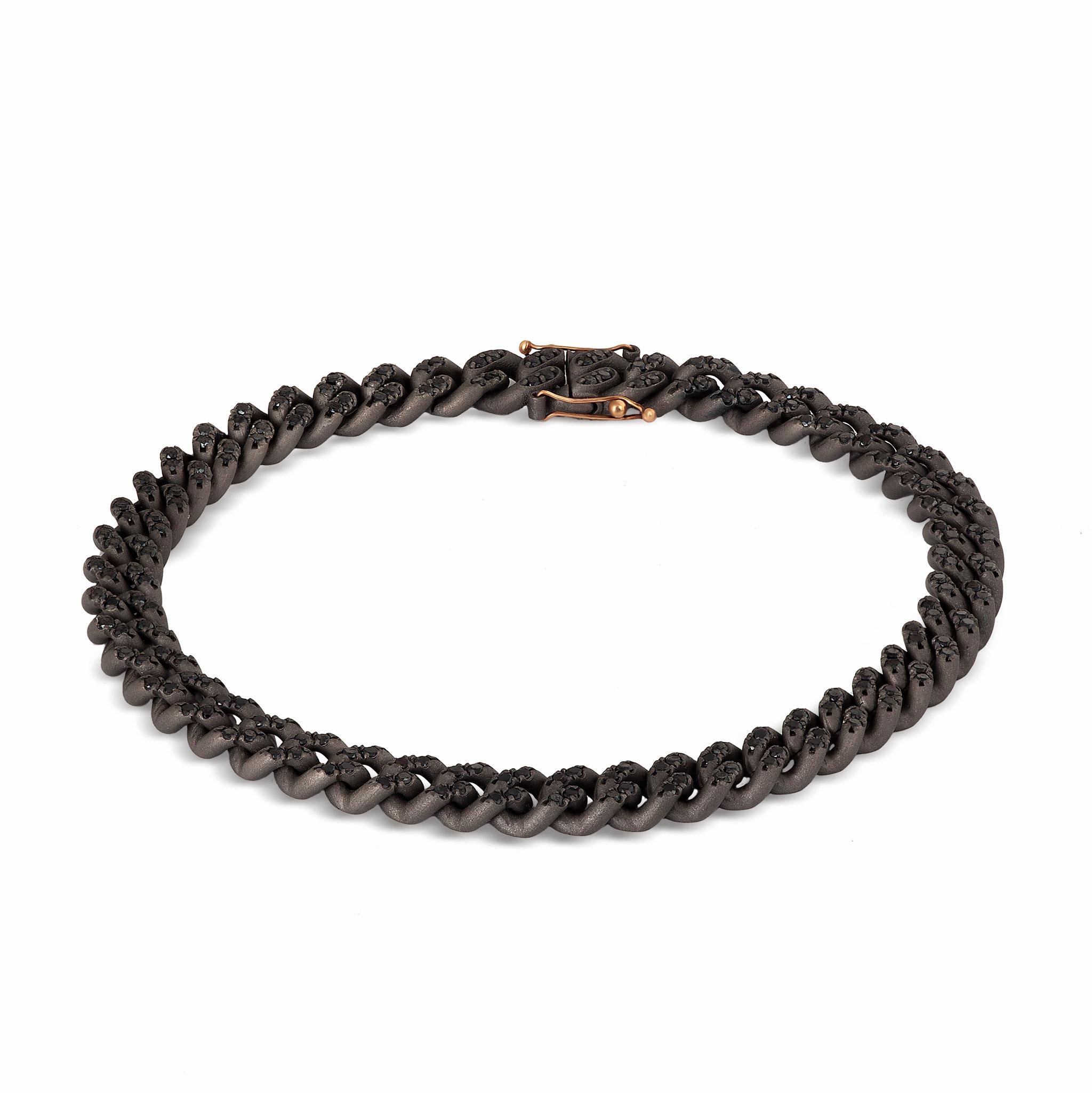 Men's groumette line bracelet in titanium, black diamonds. A splendid bracelet made entirely by hand in titanium, where a series of 29 articulated links make up the entire structure of this jewel. On each link are set four one-point black diamonds