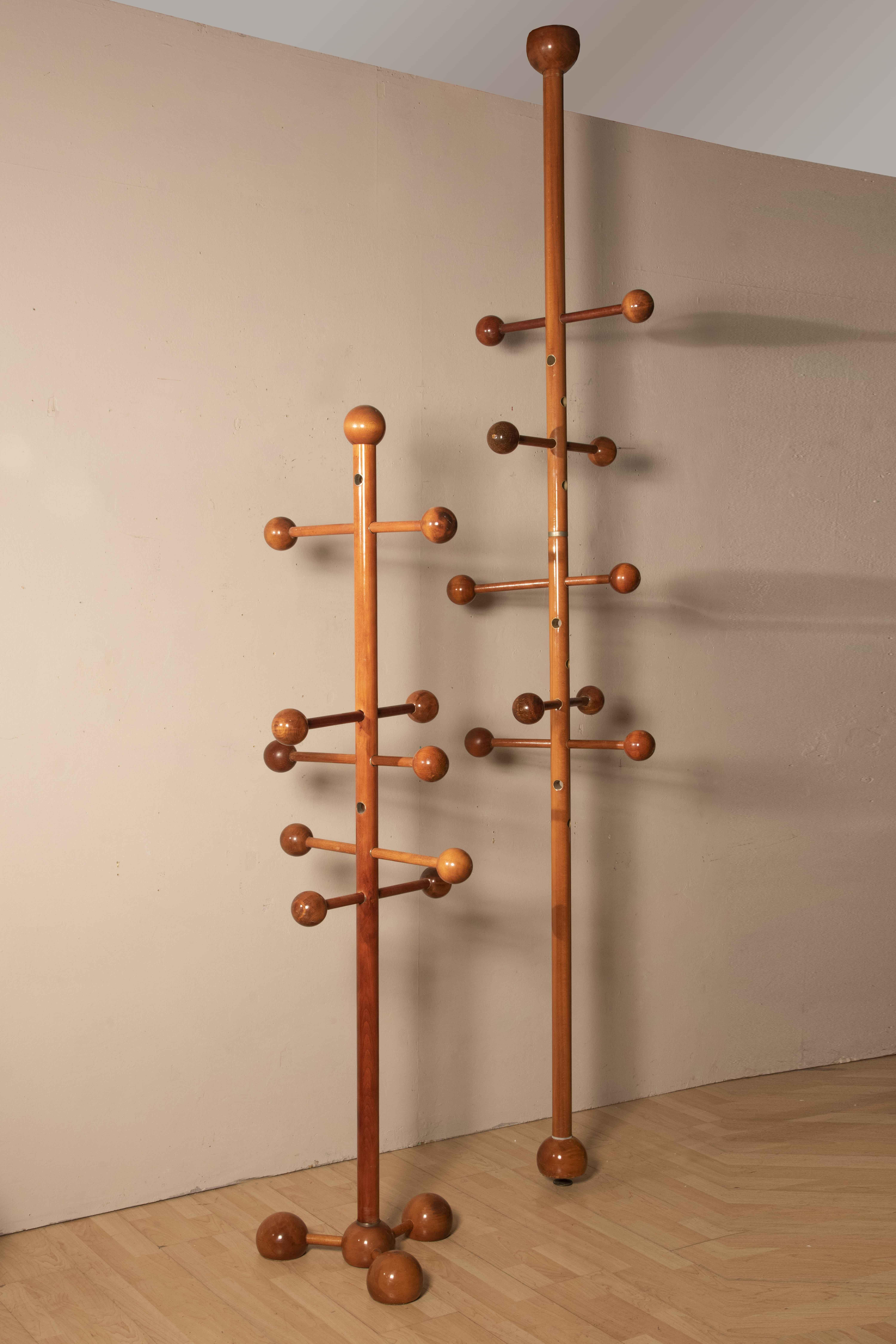 Set of two different coat hangers. the set is composed by a Ground - Ceiling coat hanger with spherical elements  together with another self standing coat hanger. Both are made of walnut wood and are from Italy from 1970s. 
Conservative restoration.