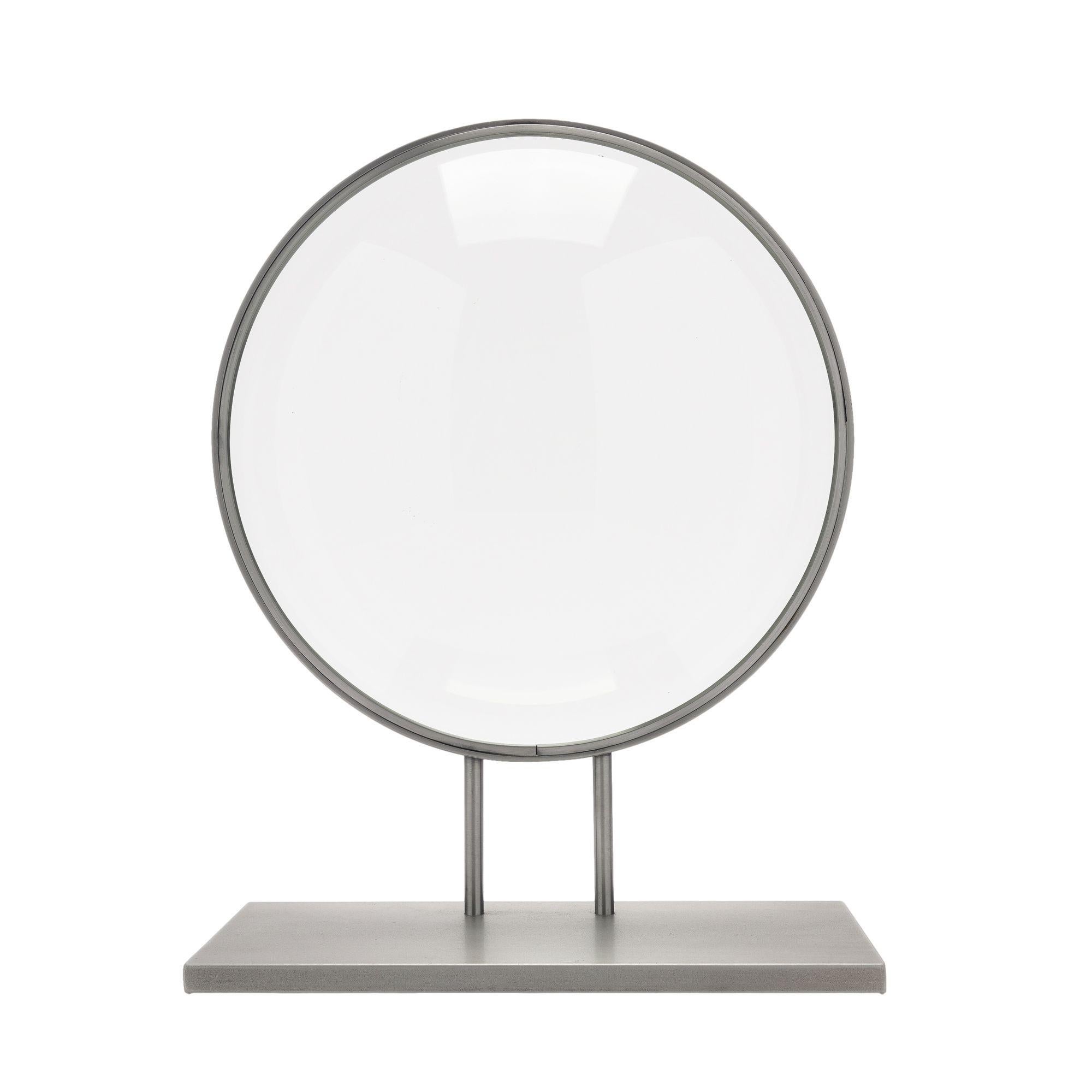 Ground and polished circular convex glass lens mounted on a custom stand.