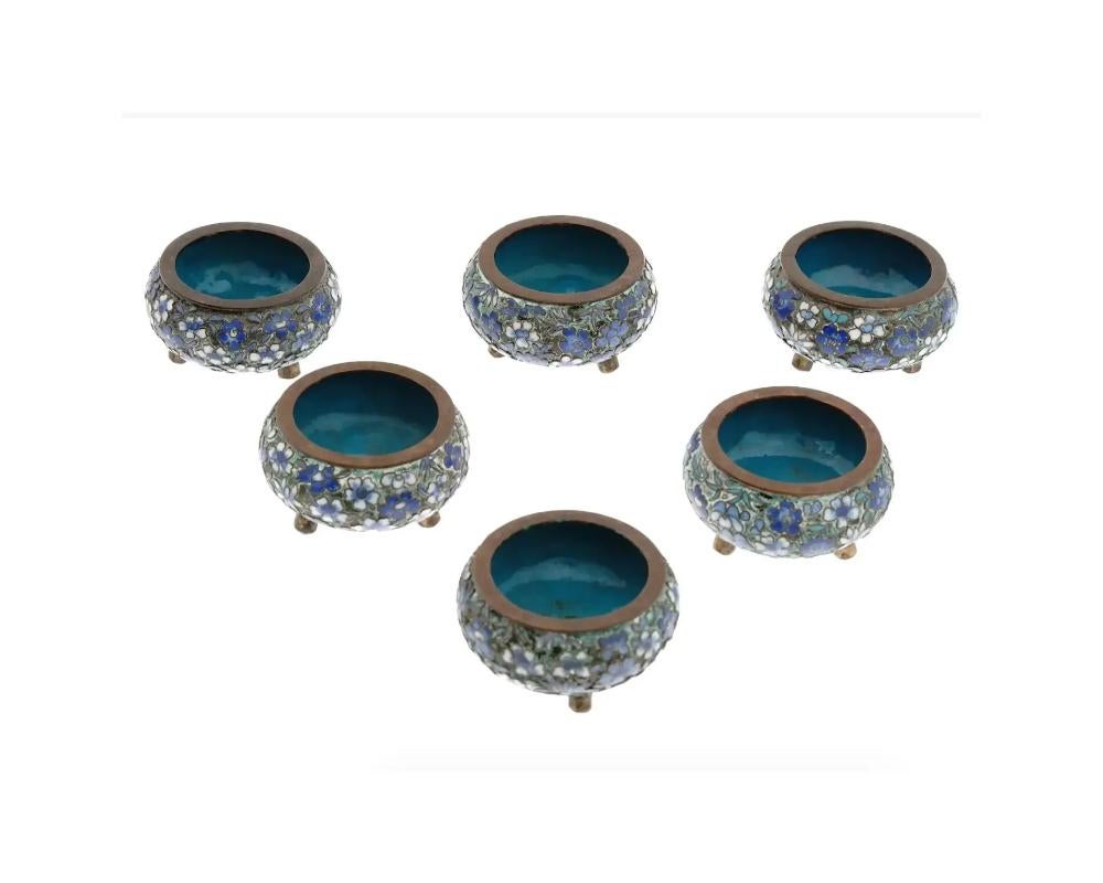 A collection of six Chinese tripod brass and enamel salt cellars. Circa: the first half of the 20th century. The wares are enameled with polychrome floral, and foliage patterns made in the Cloisonne technique. Unmarked. Antique and Vintage Asian and