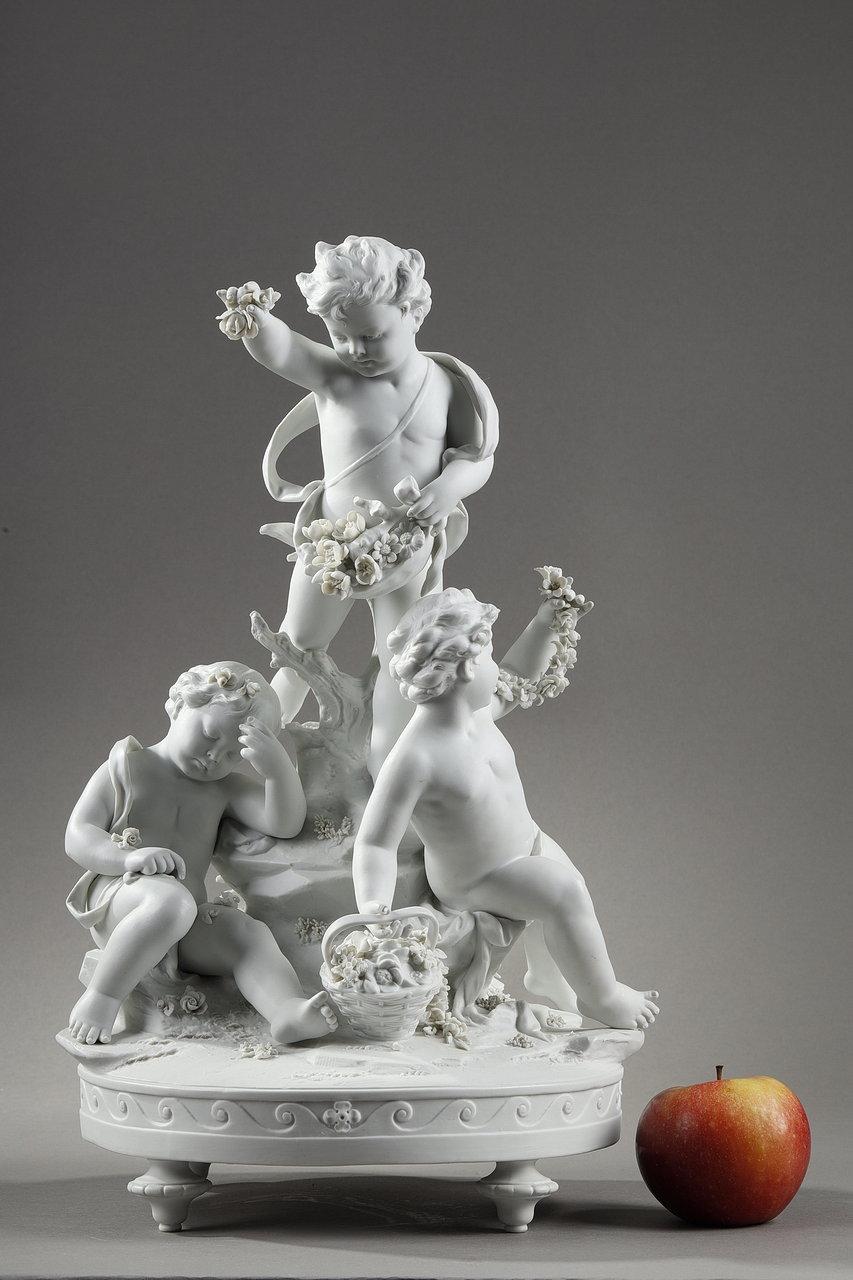 Group in biscuit of porcelain representing three young children, one seated resting on a tree trunk and the other two having fun undoing garlands of flowers. The middle putto is throwing buds at his sleeping friend while the third is enjoying a