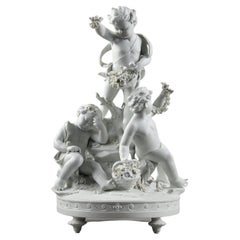 Group in biscuit of porcelain "putti with garlands and baskets of flowers", 19th