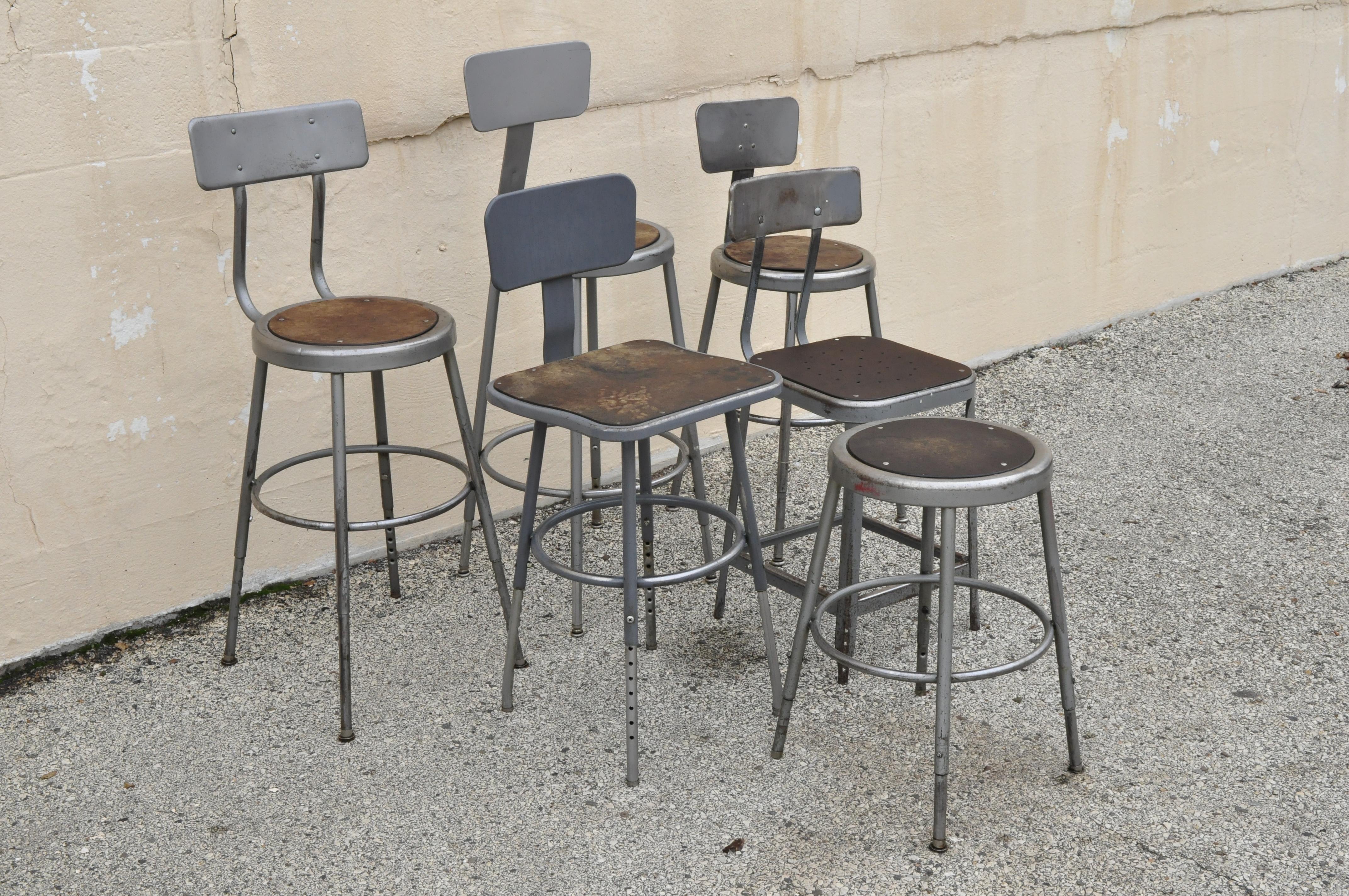 Group lot of six vintage industrial steel metal drafting work stools chairs. Listing includes a group of 6 various industrial steel metal work stools, some with adjustable backrests and height, masonile seats, very nice vintage set, quality American