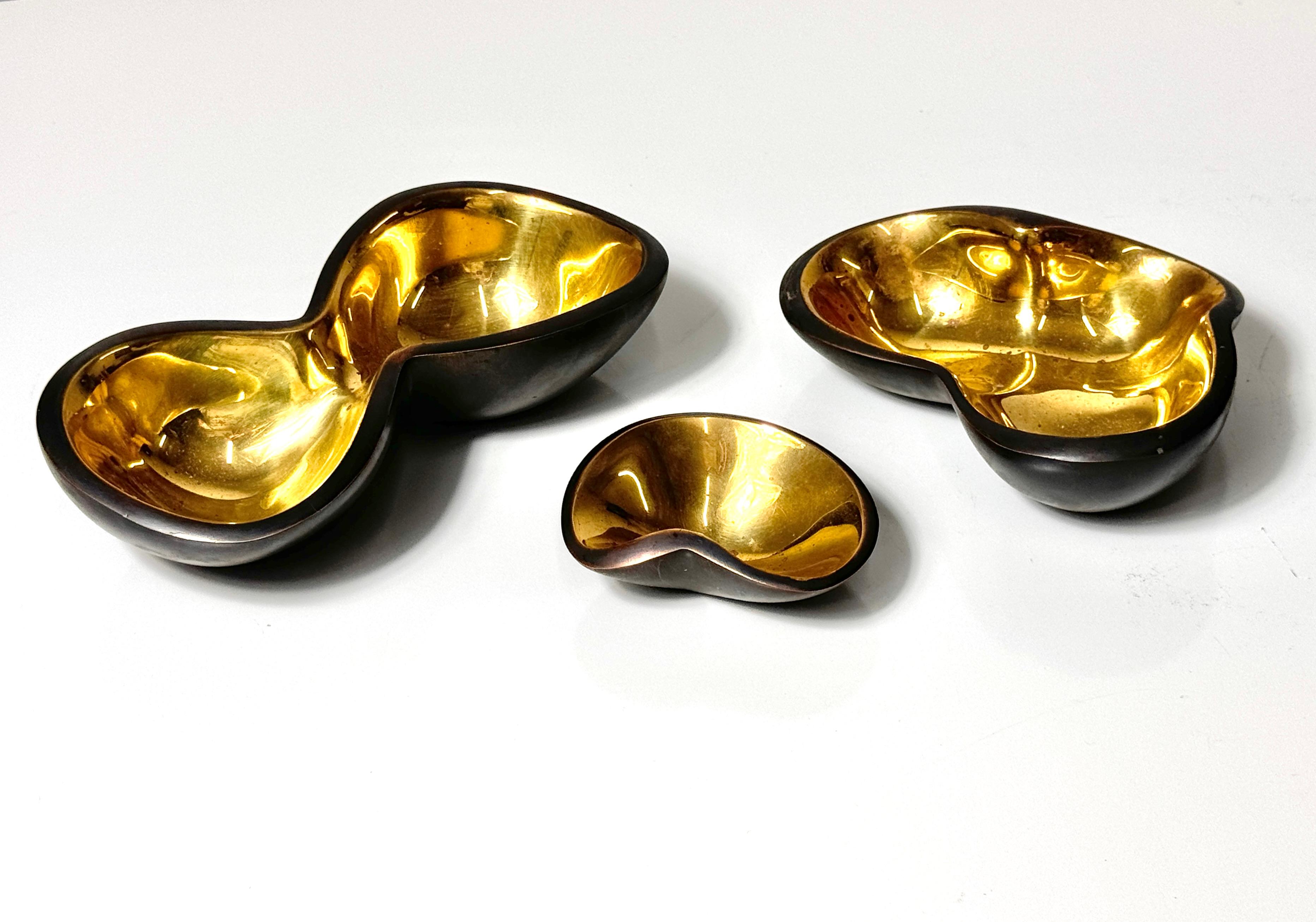 A grouping of 3 bronze biomorphic decorative bowls by Jonathan Adler
Retired design model 13020 circa 2012

Graduated size and varied organic forms in bronze with gold interior
Impressed mark to underside of each

Dimensions:
3.25 - 7 inch width
2.5