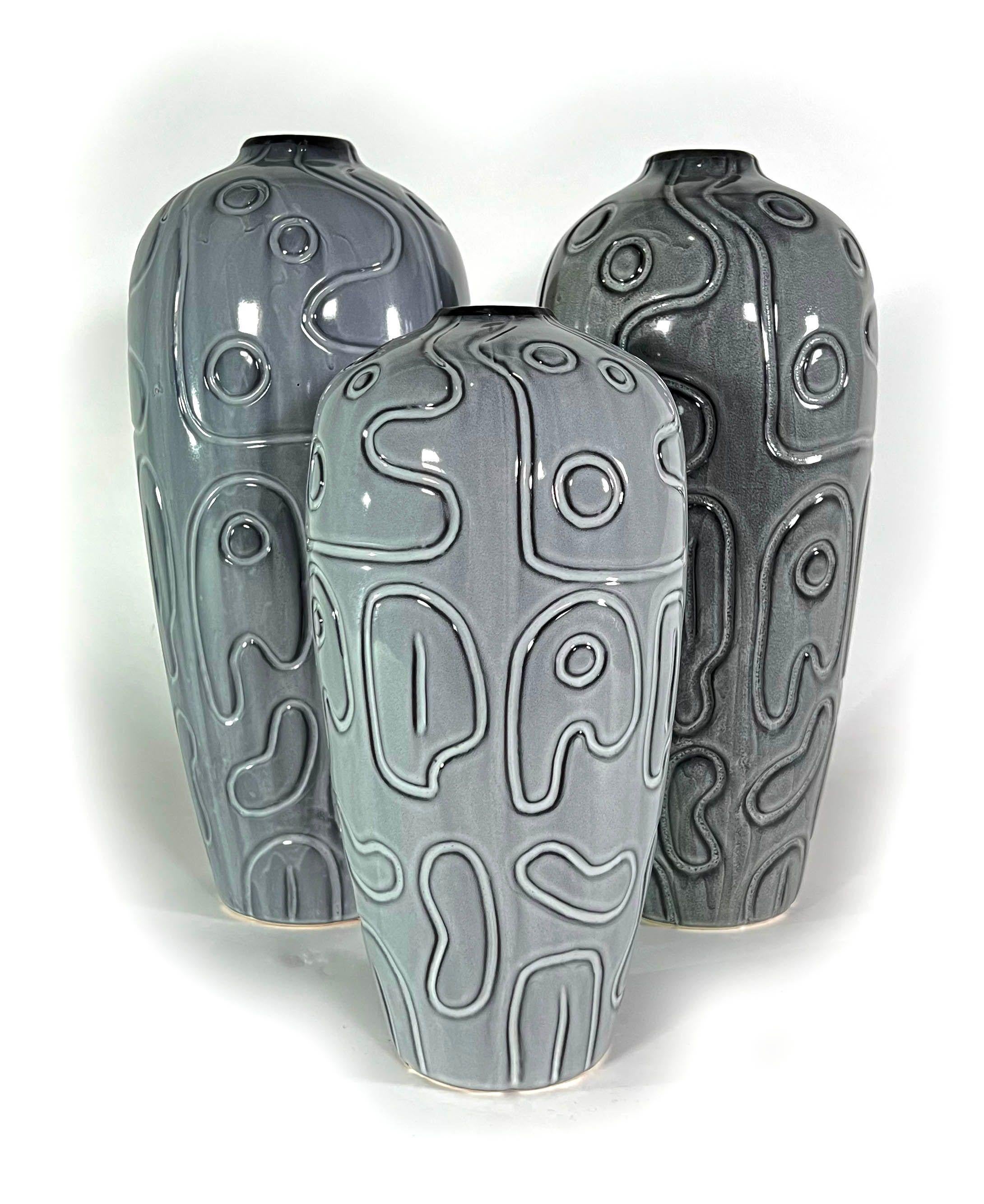 Each with incised abstract decoration and a gray gloss glaze

Measures: 16.5