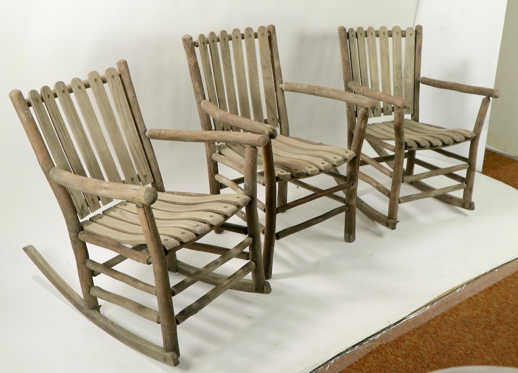 Nice set of three porch chairs, to include 2 rocking, and 1 armchair, all marked Old Hickory. The chairs are in excellent structural condition, sturdy, tight and ready to use. All 3 show weathering to finish, normal and consistent with age. Offered