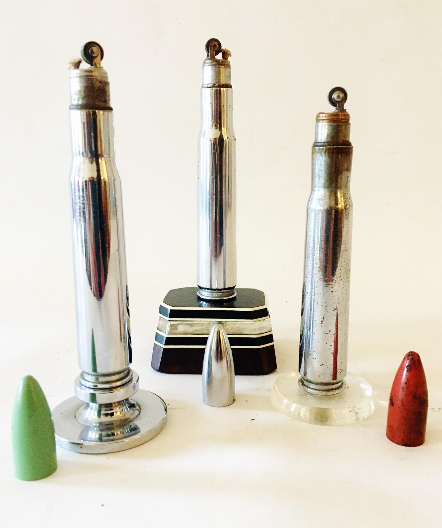 This group of 3 American Art Deco, Trench Art, wheel and flint table lighters feature chrome bodies mounted on different bases and with different colored 