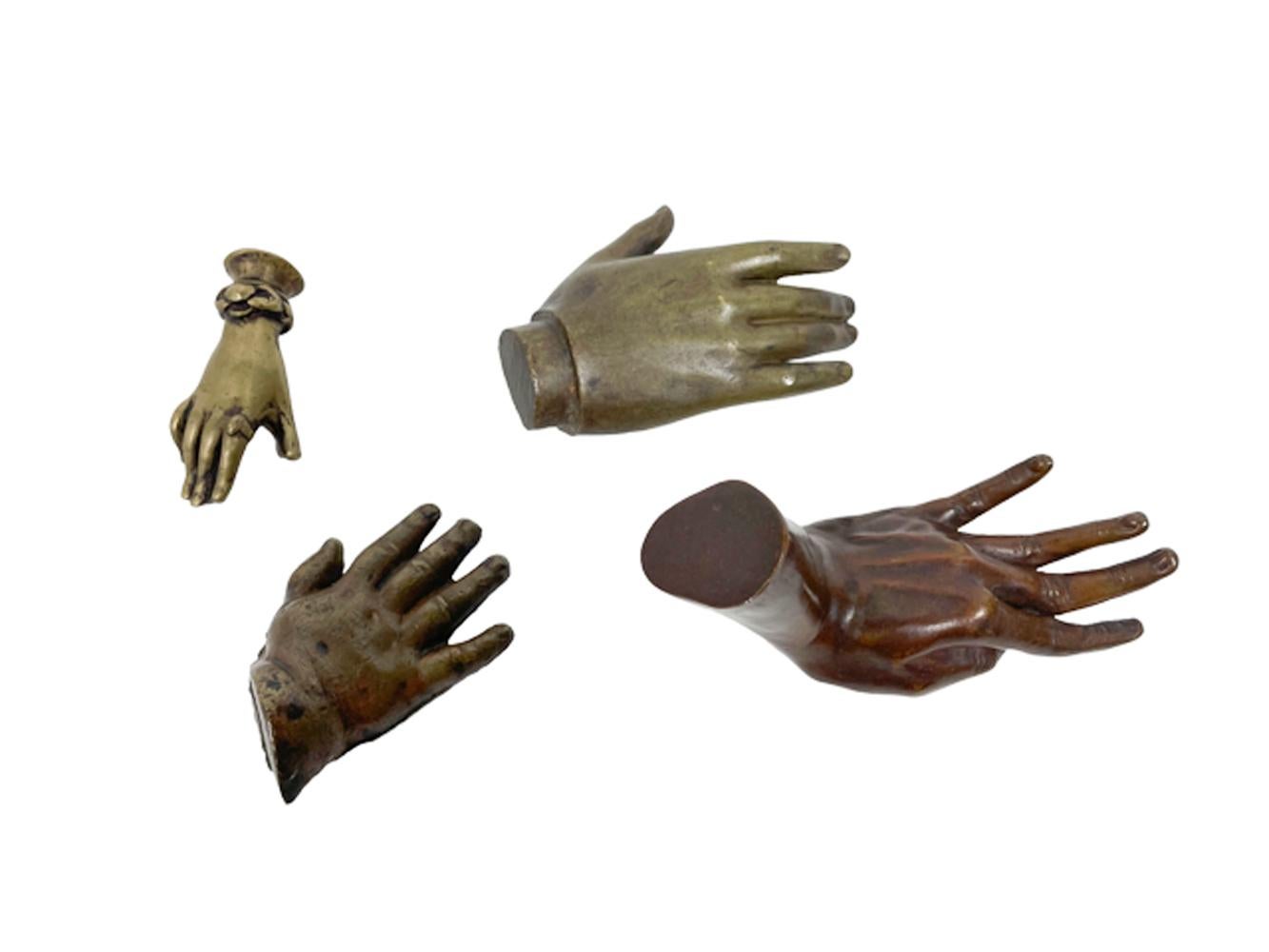 Group of late nineteenth through early twentieth century realistic cast brass and bronze models of hands, one with a ring and bracelet. 
Measurements:
2.5