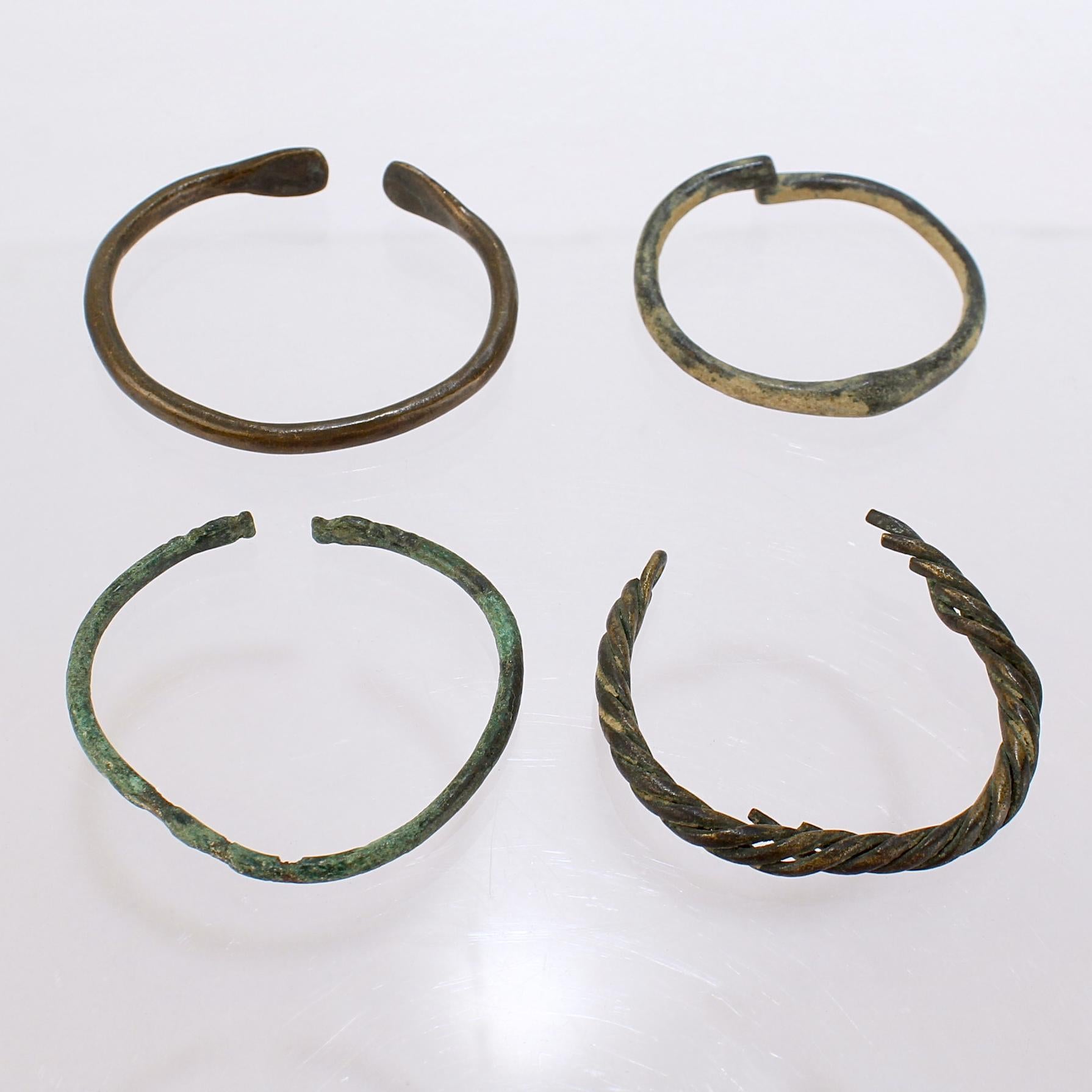 A group of ancient Roman bronze bracelets.

One with a twist design. One with planished tips.

From the private collection of Lawrence Majewski, who was a former conservator at the Metropolitan Museum of Art. 

Simply a wonderful piece for the