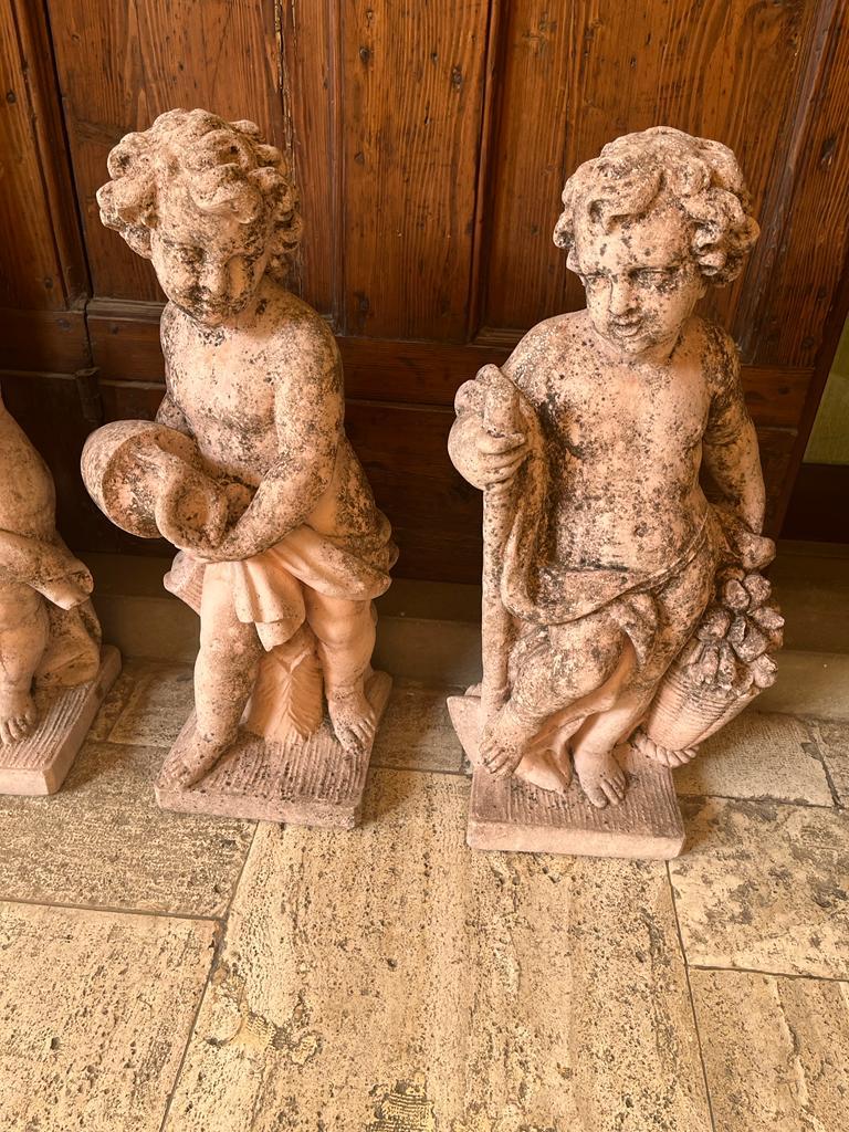 Group of 4 grit Putti depicting the 4 Elements Earth, Sky, Air, and Fire 1930s period. 
The Putti of great quality imitates the genre of Louis XIV.