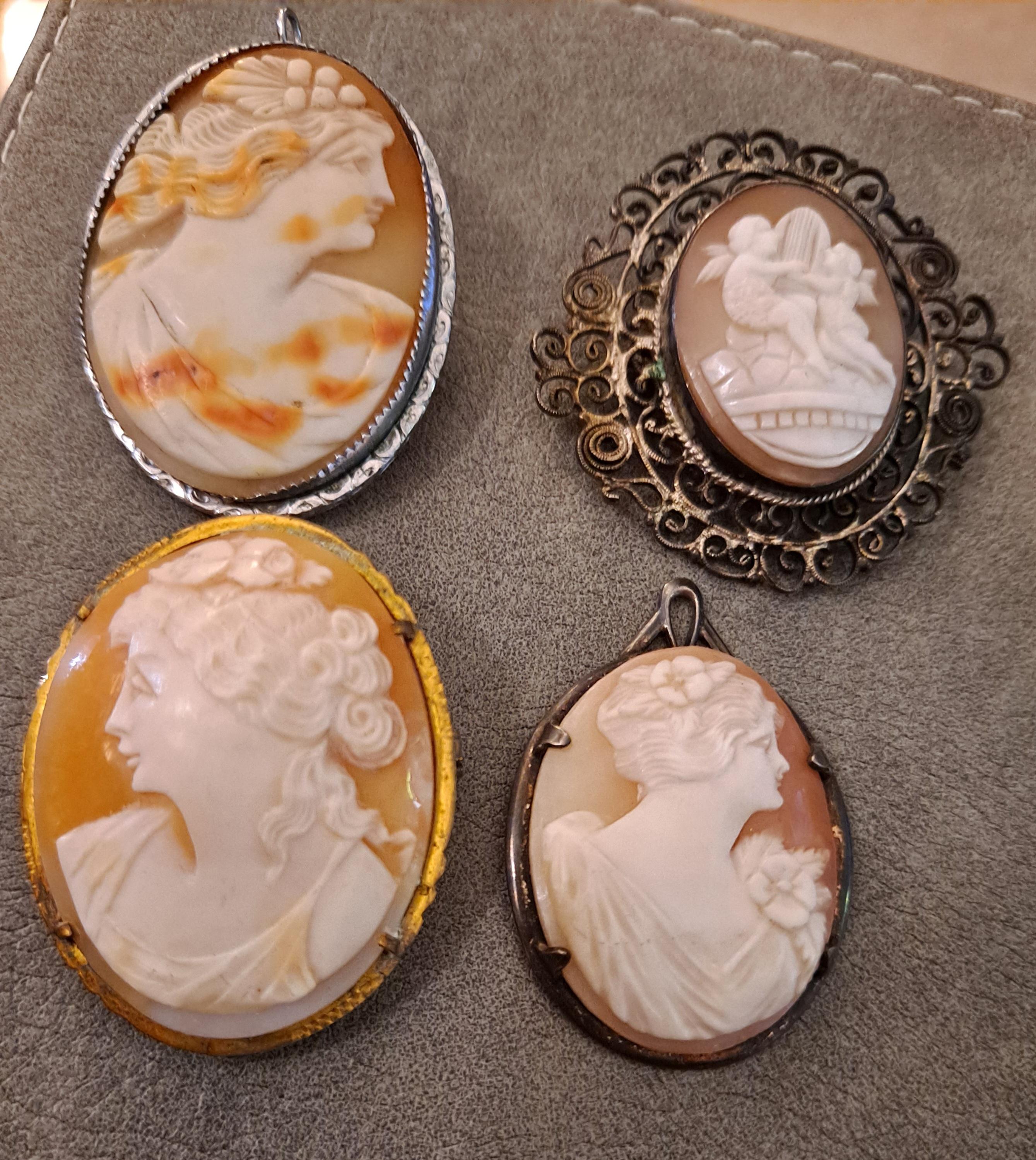 Group of 4 High Relief Cameo Pins/Pendents Carved from Bull Mouth Shell

Unmarked

Silver Settings

2.5mm x 4mm 
4mm x 4mm
2 pieces: 3mm x 3mm