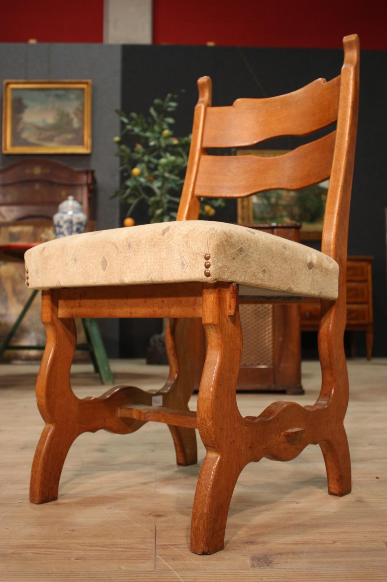 Group of 4 rustic chairs, from northern Europe, from the mid-20th century. Furniture carved in oakwood. Seats covered in light fabric in good condition, with some small signs of aging. Padding in good condition. Living room or dining room chairs